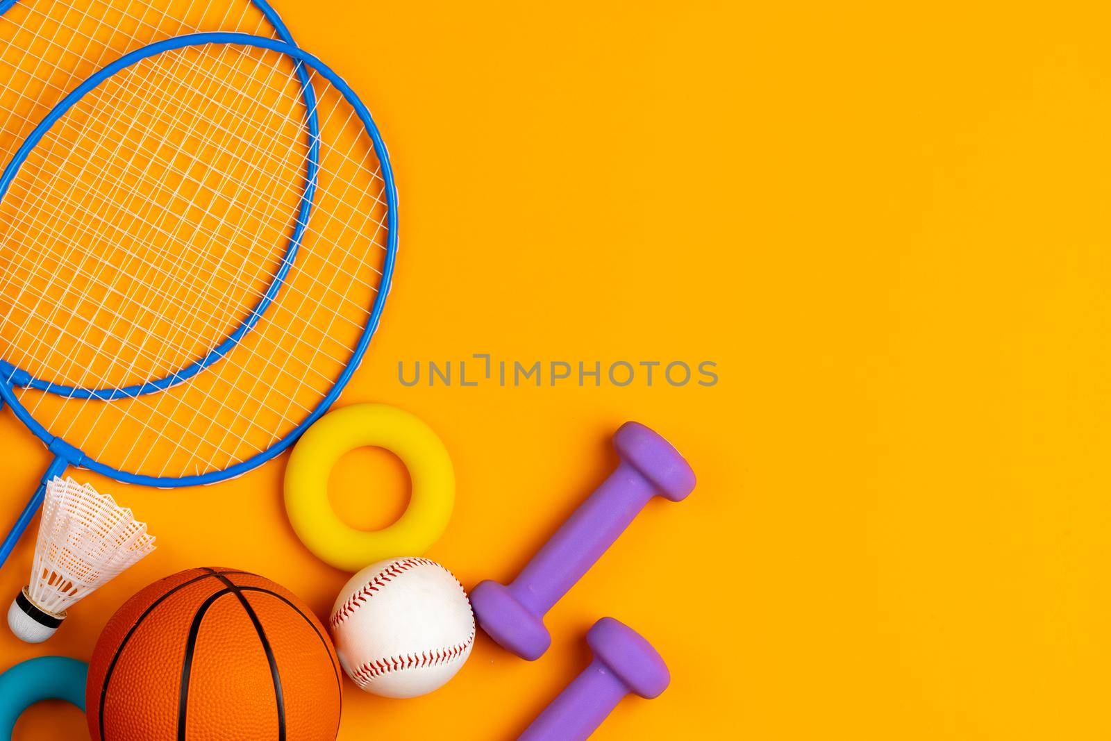 Assortment of sport equipment on yellow background, top view. High quality photo