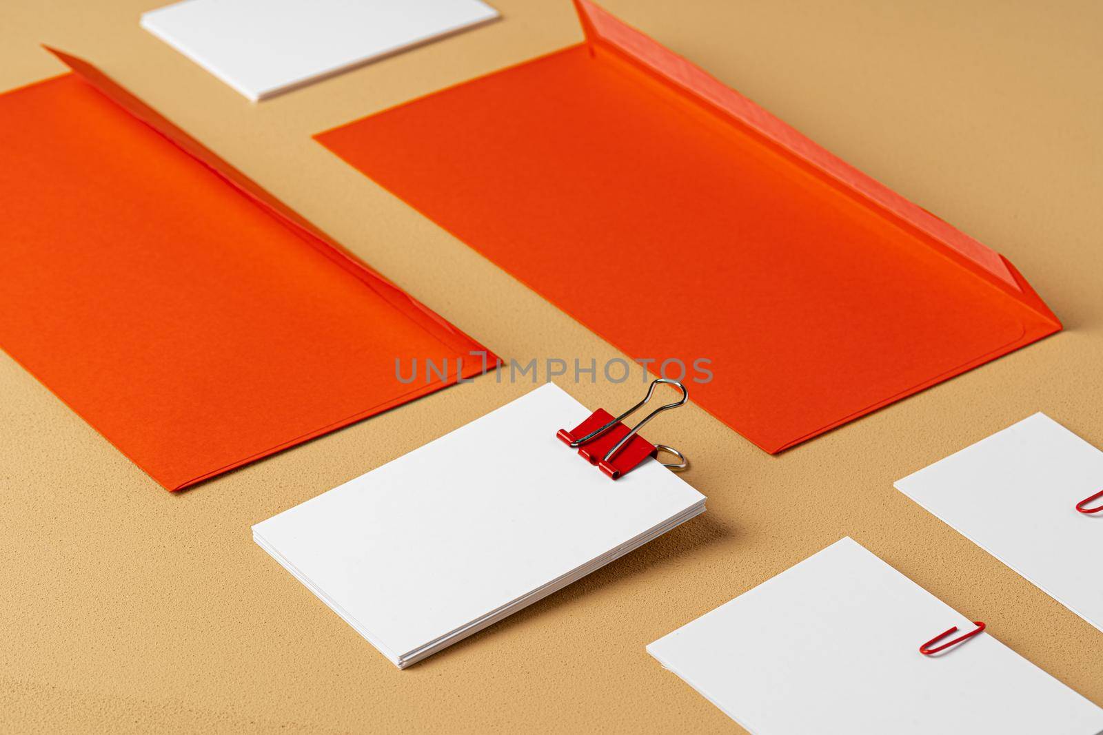 Red and white blank branding paper on beige background, copy space