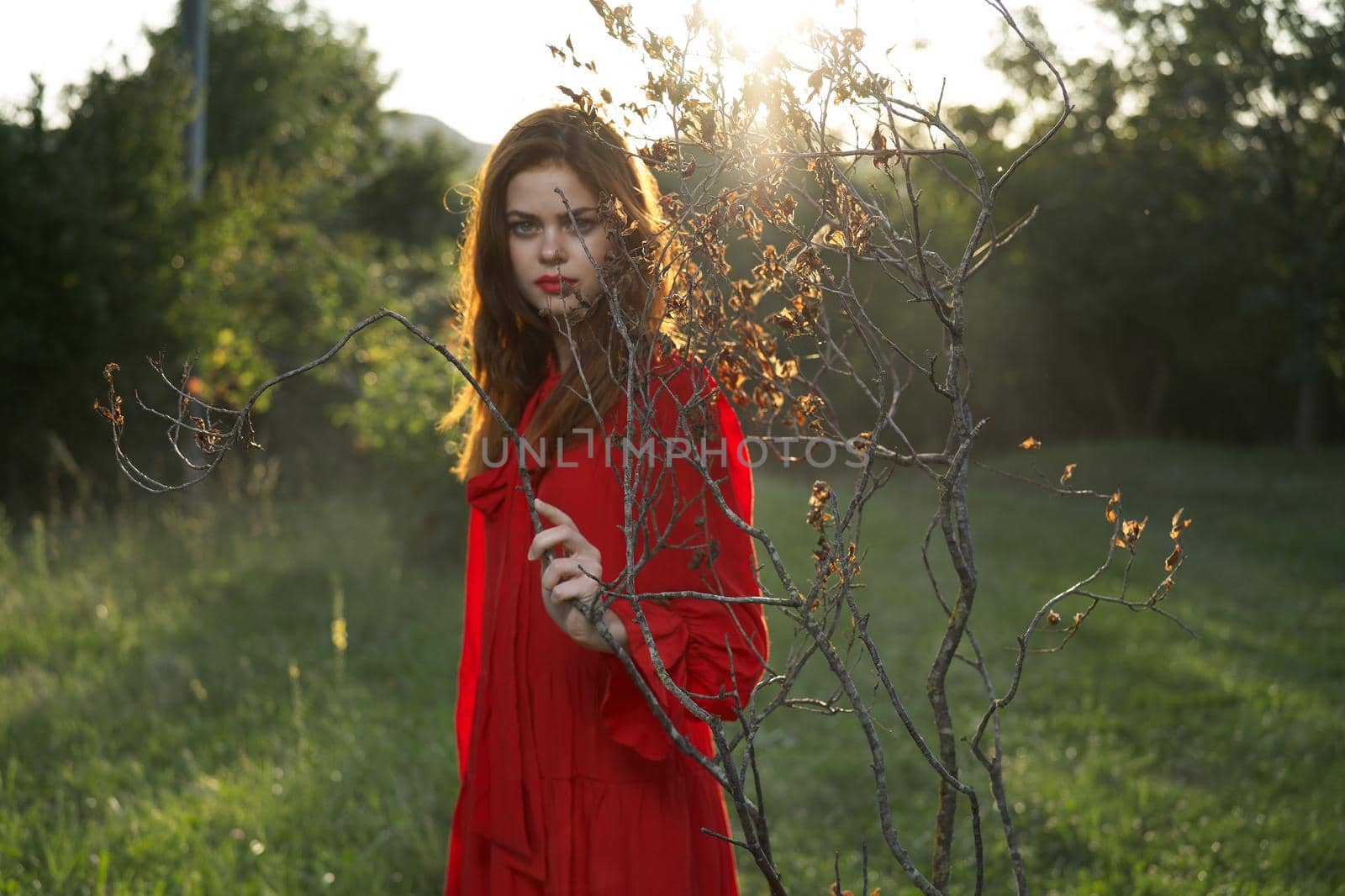 attractive woman in red dress outdoors fresh air summer. High quality photo