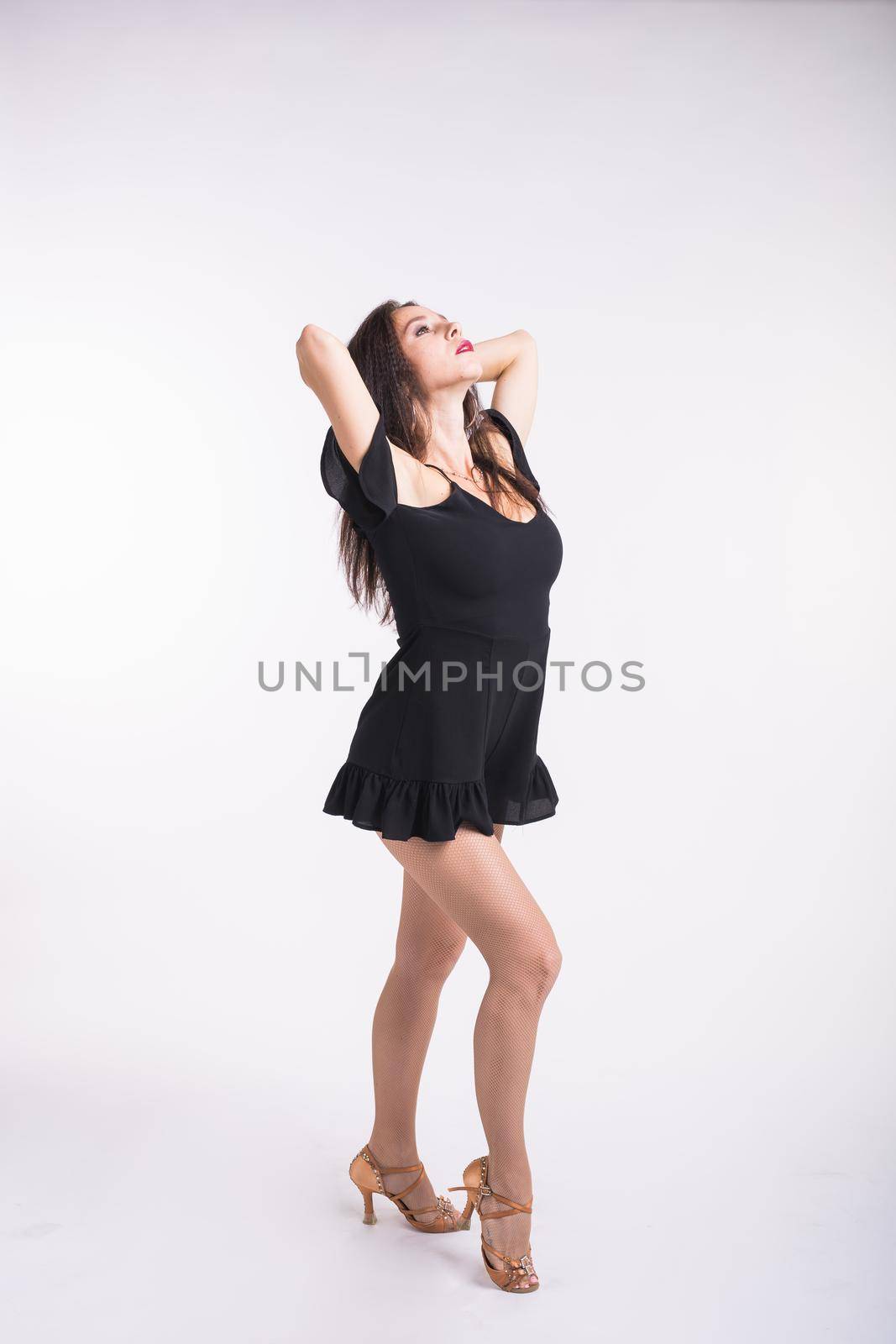 Latina dance, strip dance, contemporary and bachata lady concept - Woman dancing improvisation and moving her long hair on a white background. by Satura86