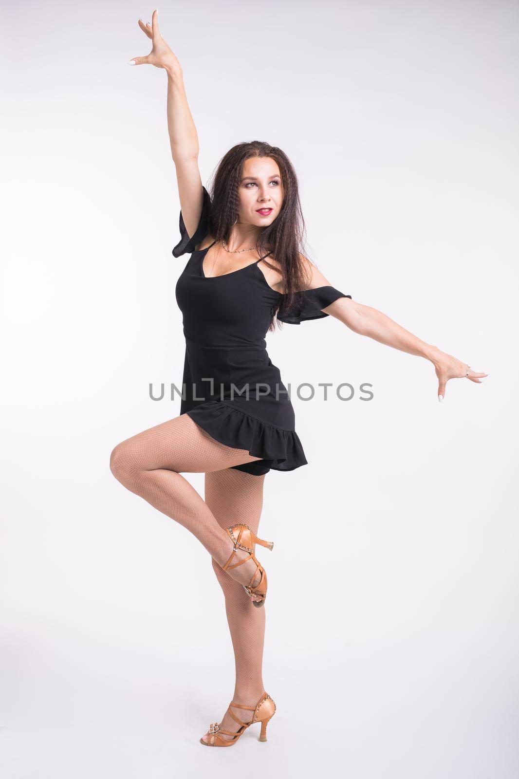 Latina dance, strip dance, contemporary and bachata lady concept - Woman dancing improvisation and moving her long hair on a white background