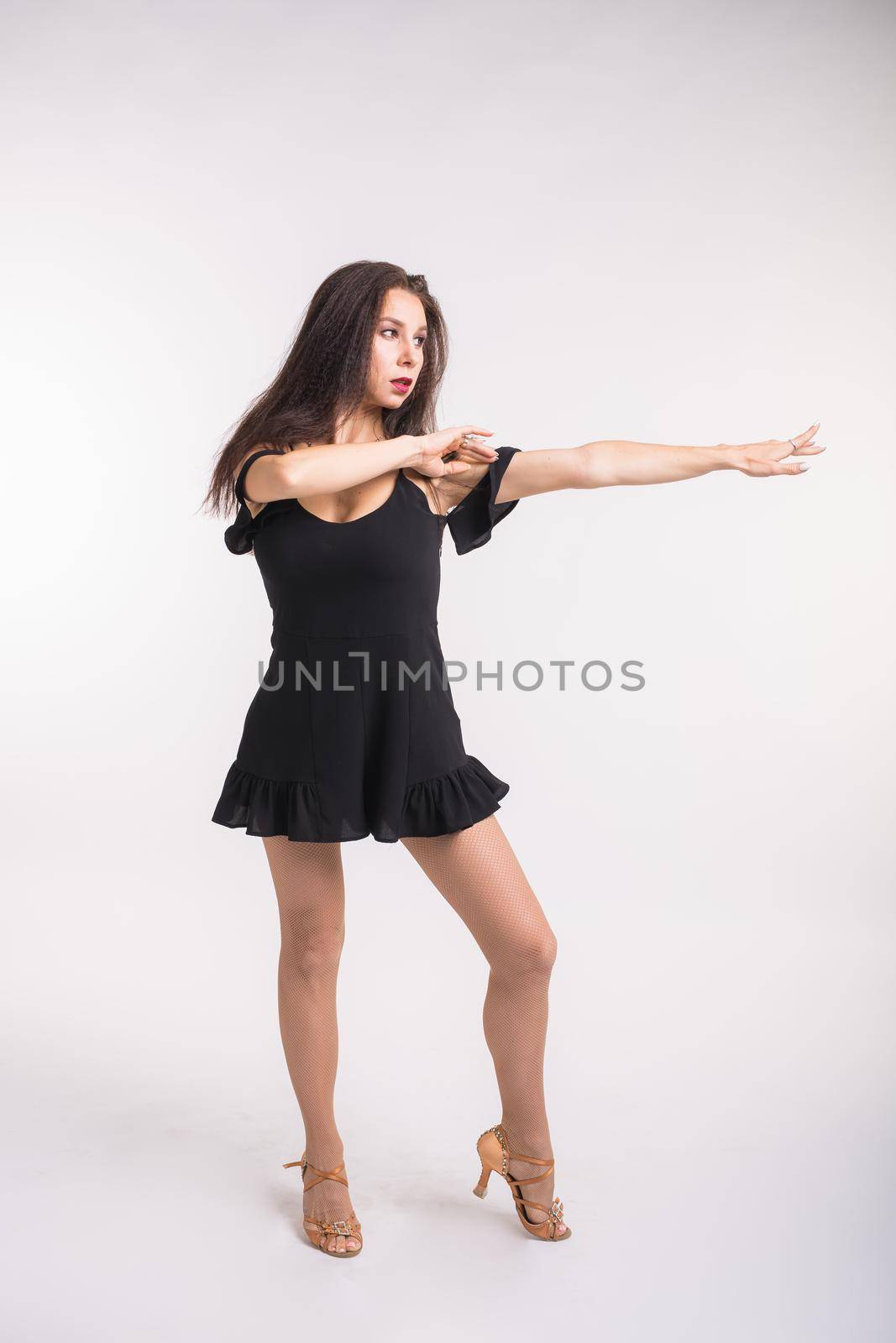 Latina dance, strip dance, contemporary and bachata lady concept - Woman dancing improvisation and moving her long hair on a white background