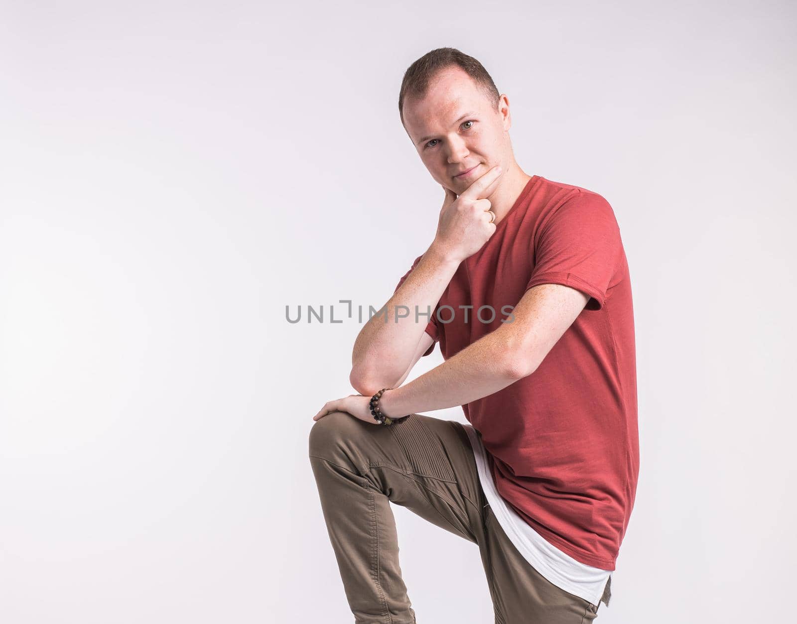 Attractive young man dancing, having fun on white background. Stylish outlook. by Satura86