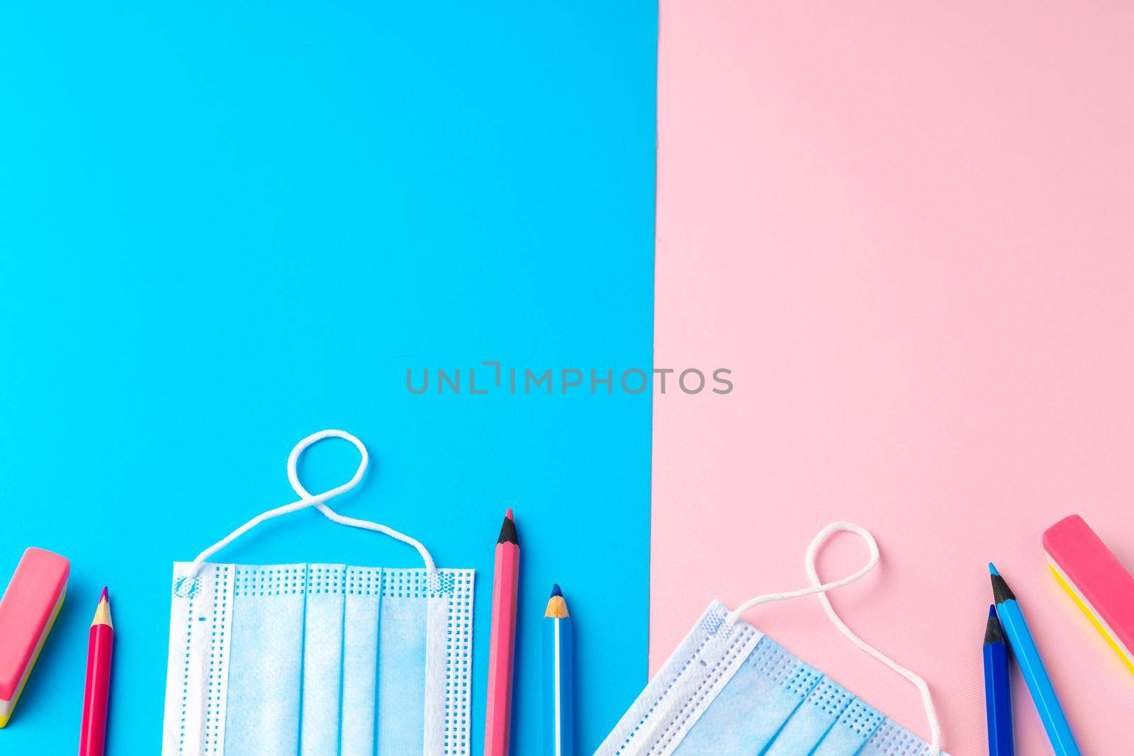 School stationery items and medical face mask, top view