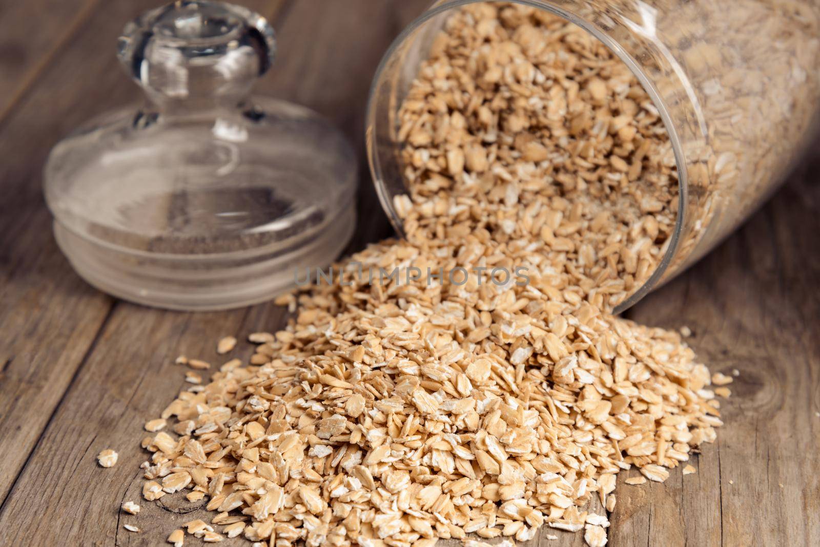 Oatmeal in the pot on a wooden table
