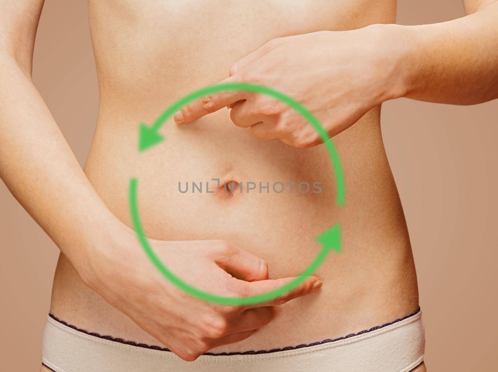 Woman points to the abdomen, arrows on the stomach, concept of comfortable digestive system