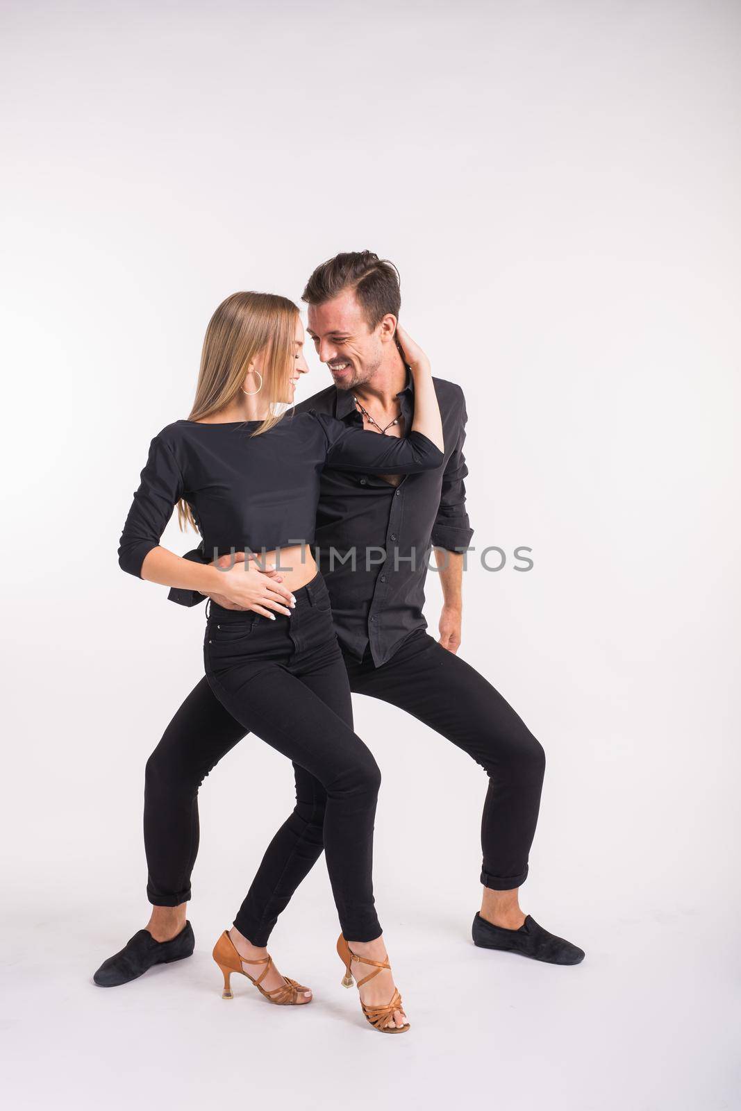 Beauty couple dancing social dance. Kizomba or bachata or semba or taraxia , on white background.