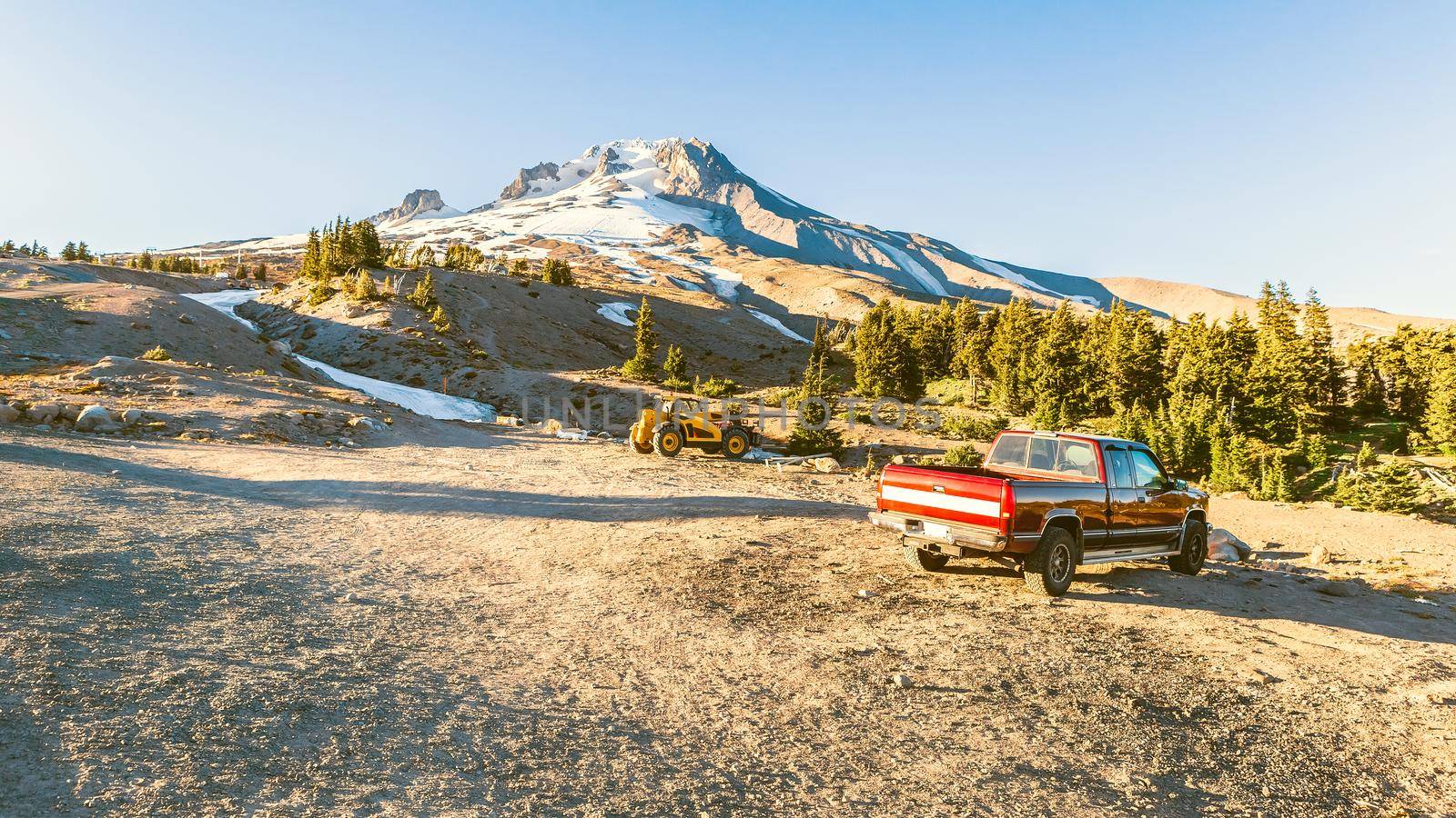 The Top of Mt. Hood, Oregon, and a red pickup truck on the foreground