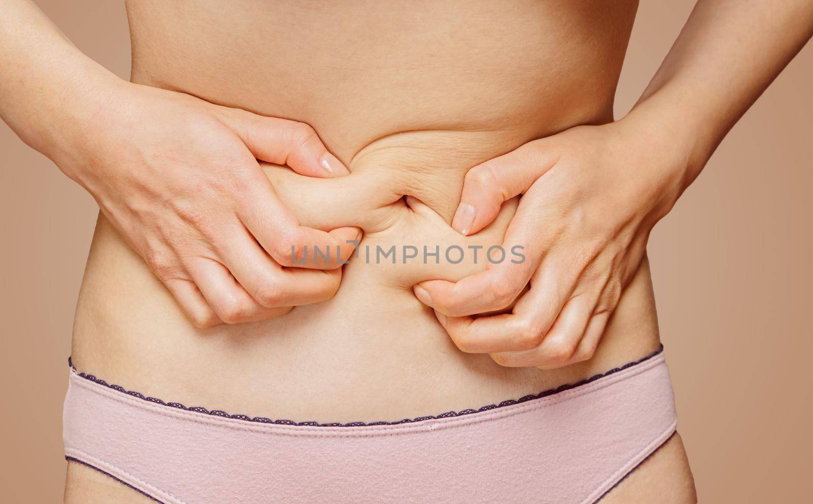 Unrecognizable woman holds her abdomen, menstrual pain