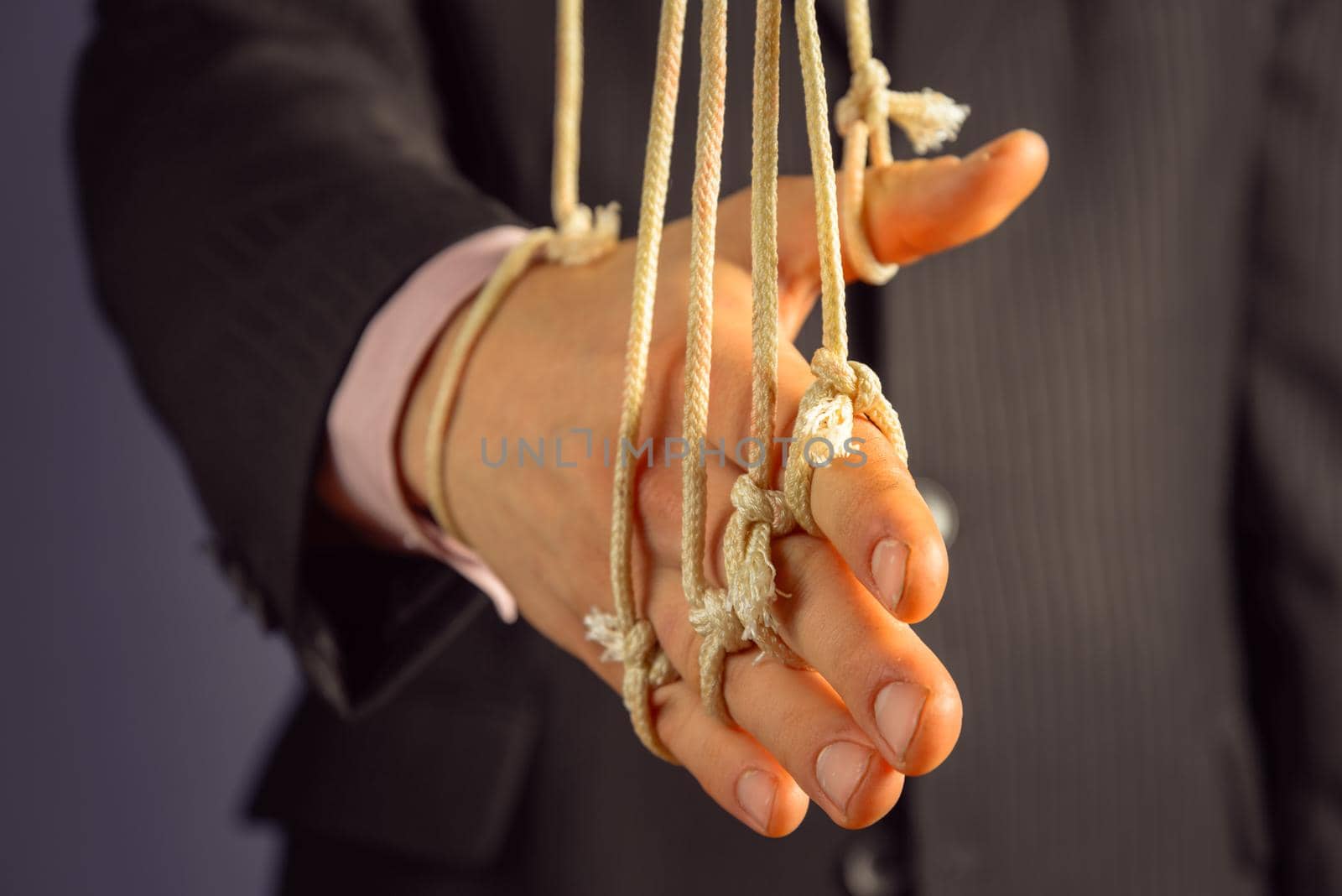 Unrecognizable businessman gives a handshake, hand on the ropes
