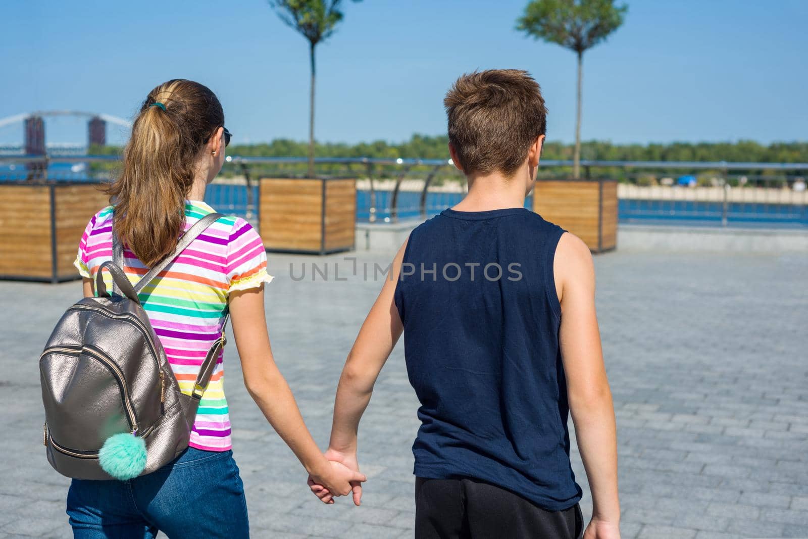 Young couple. View from the back, urban style background.