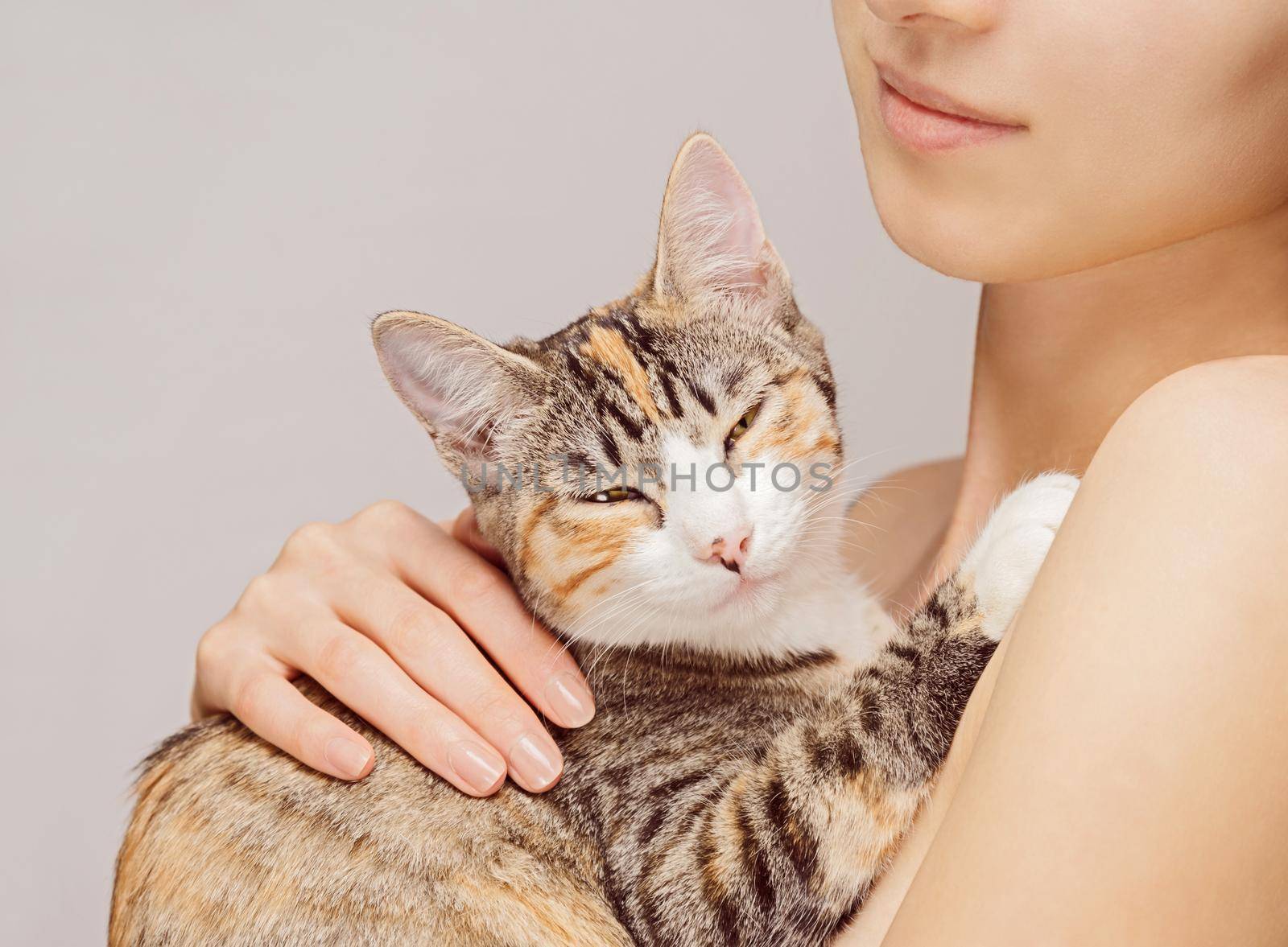 Happy woman holds orange tabby cat