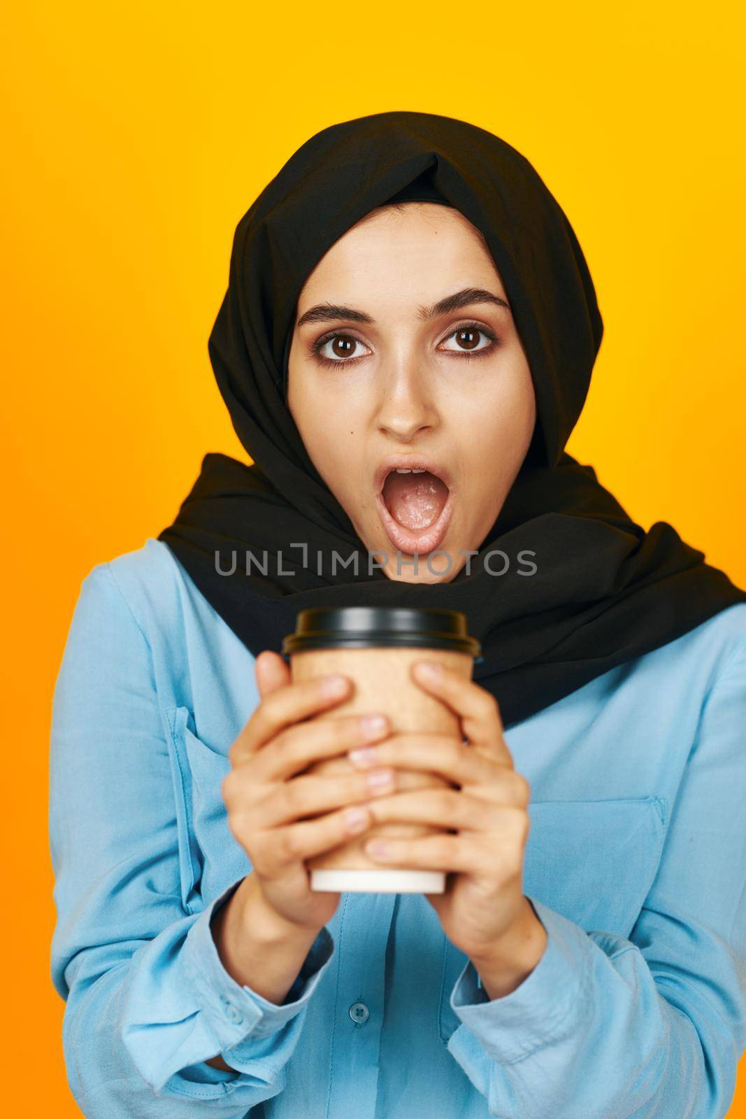 Muslim drinking a warming invigorating drink posing isolated background. High quality photo