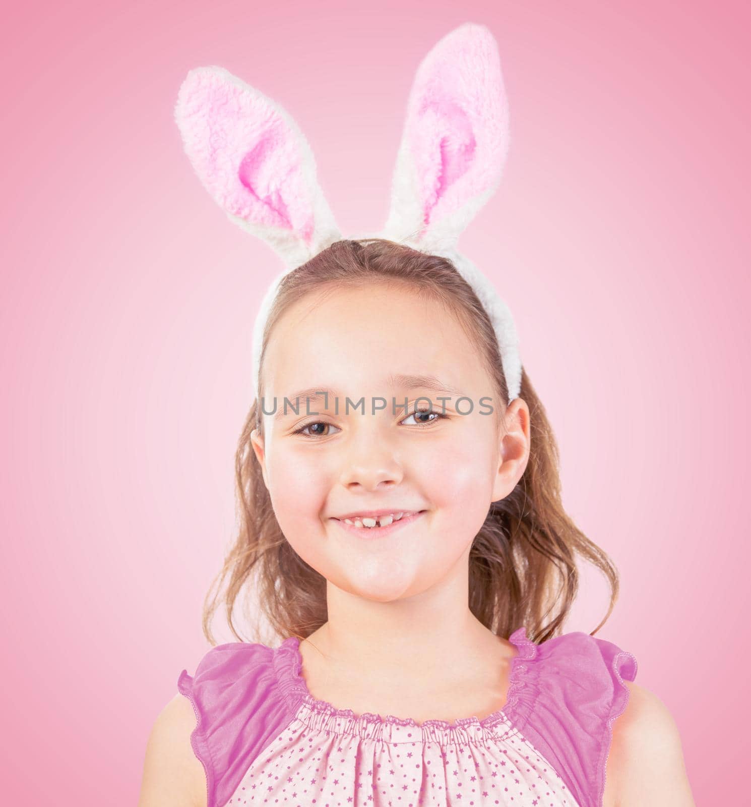 Little girl in Easter bunny ears smiles by alexAleksei