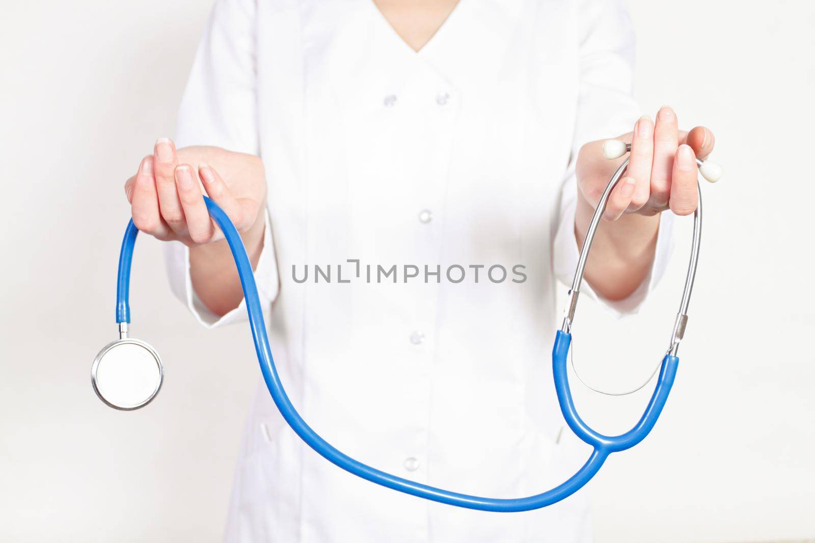 doctor gives the woman in the hands of a stethoscope