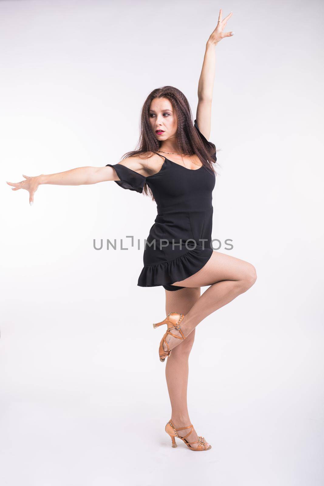 Latina dance, strip dance, contemporary and bachata lady concept - Woman dancing improvisation and moving her long hair on a white background. by Satura86
