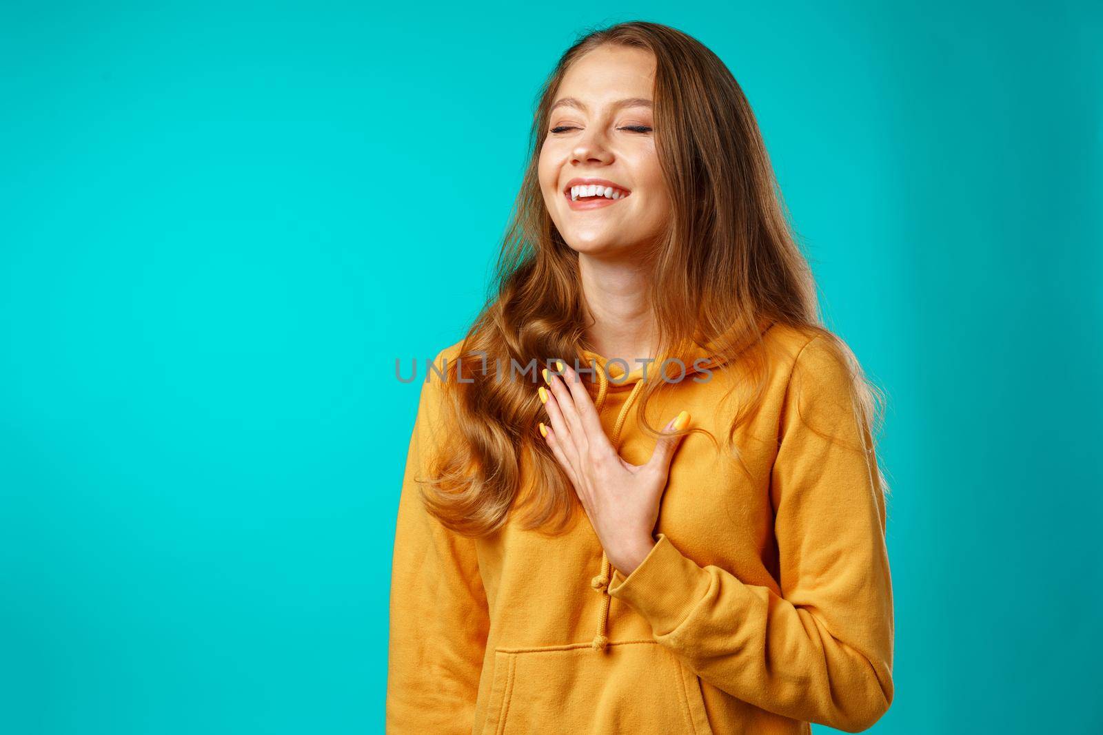 Young attractive cheerful girl laughing with joy close up