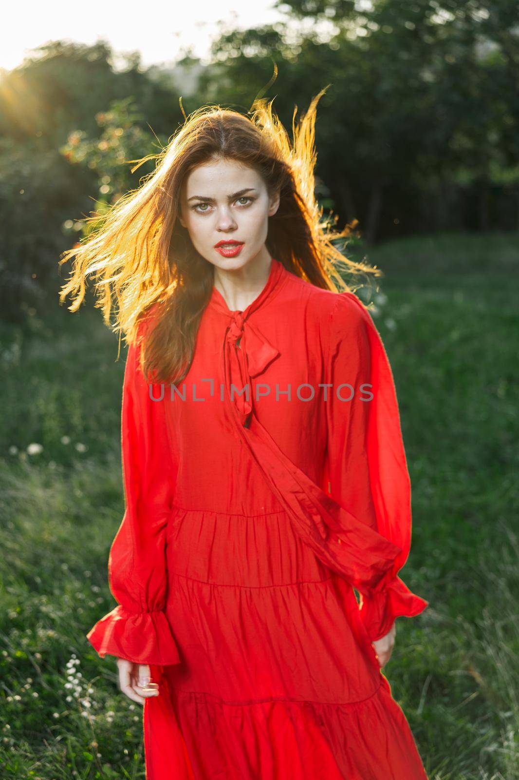 attractive woman in red dress outdoors in freedom field by Vichizh