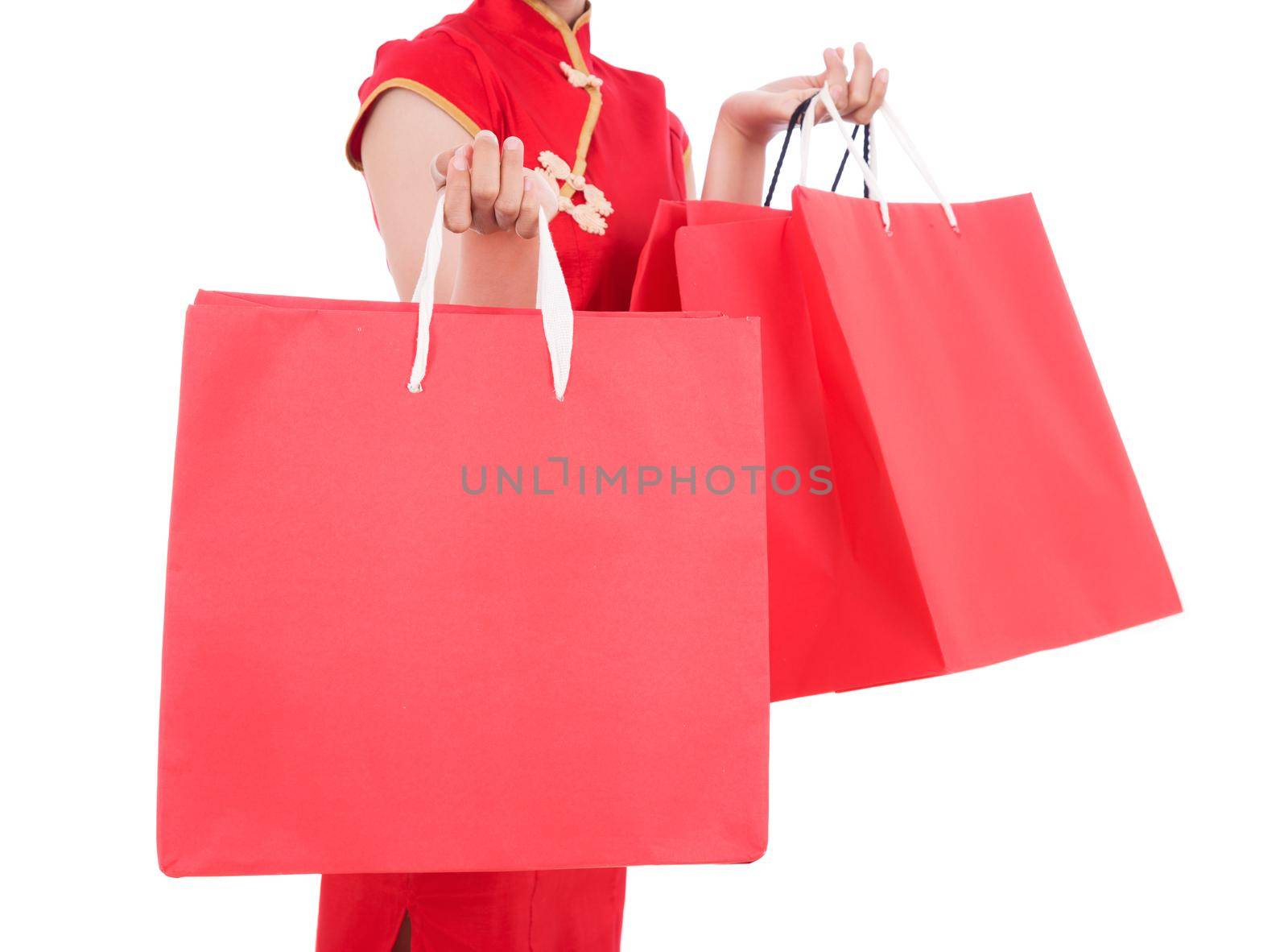 close up of shopping bag in hand of woman on chinese new year celebration isolated on a white background
