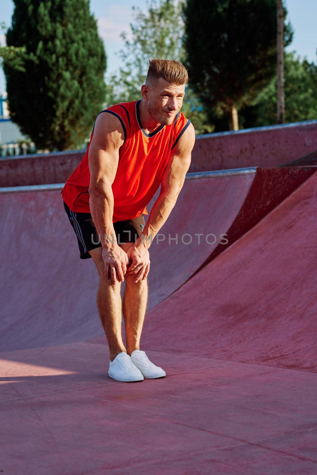 sports man on the playground in the park workout. High quality photo