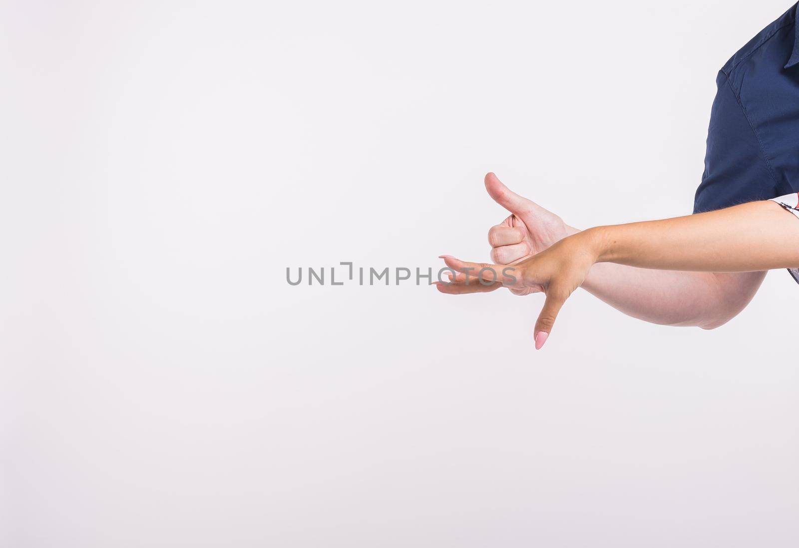 Couple pointing at the left corner with fingers standing isolated over white background. Copy space for product advertisement. by Satura86