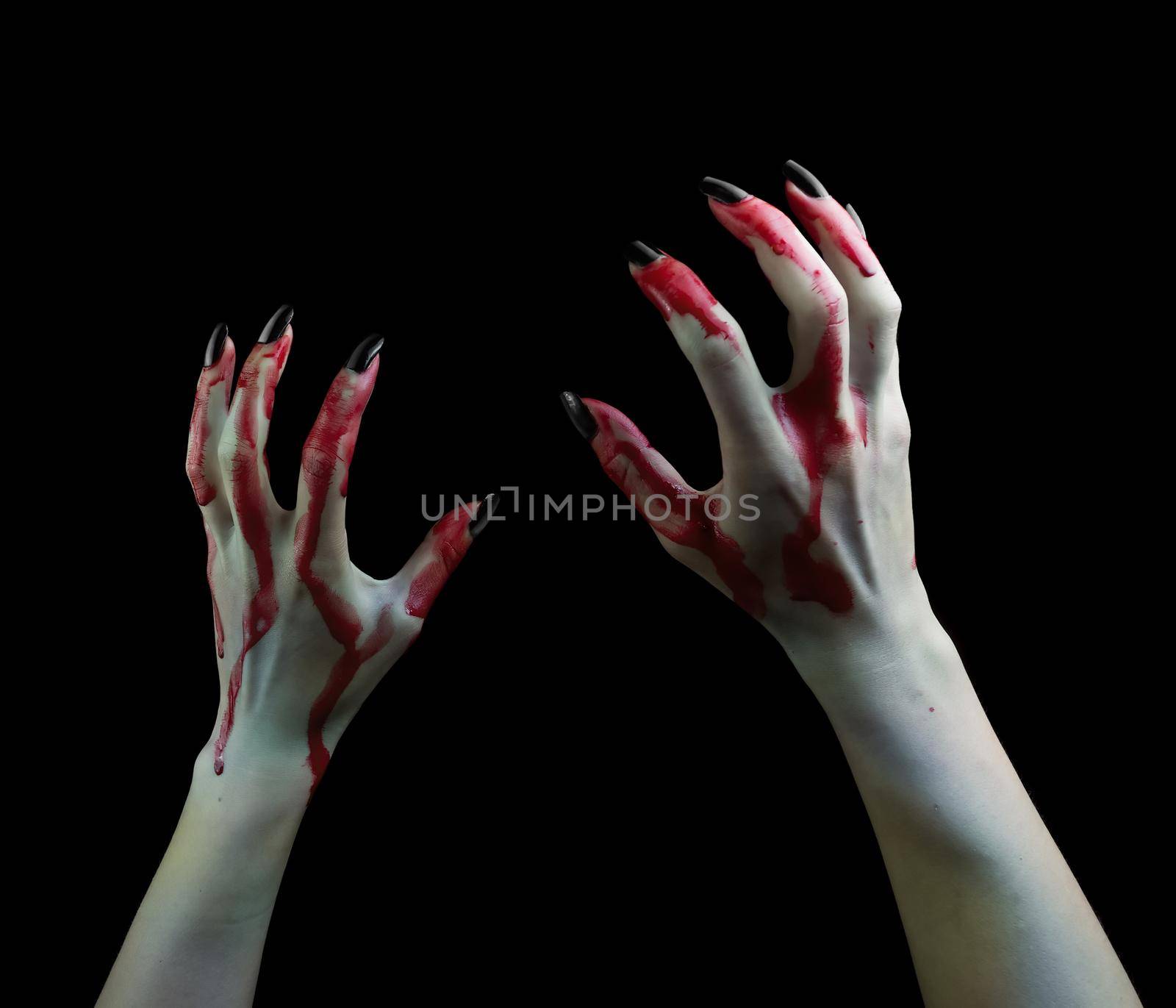 hands in the blood of a vampire drawn up on black background.