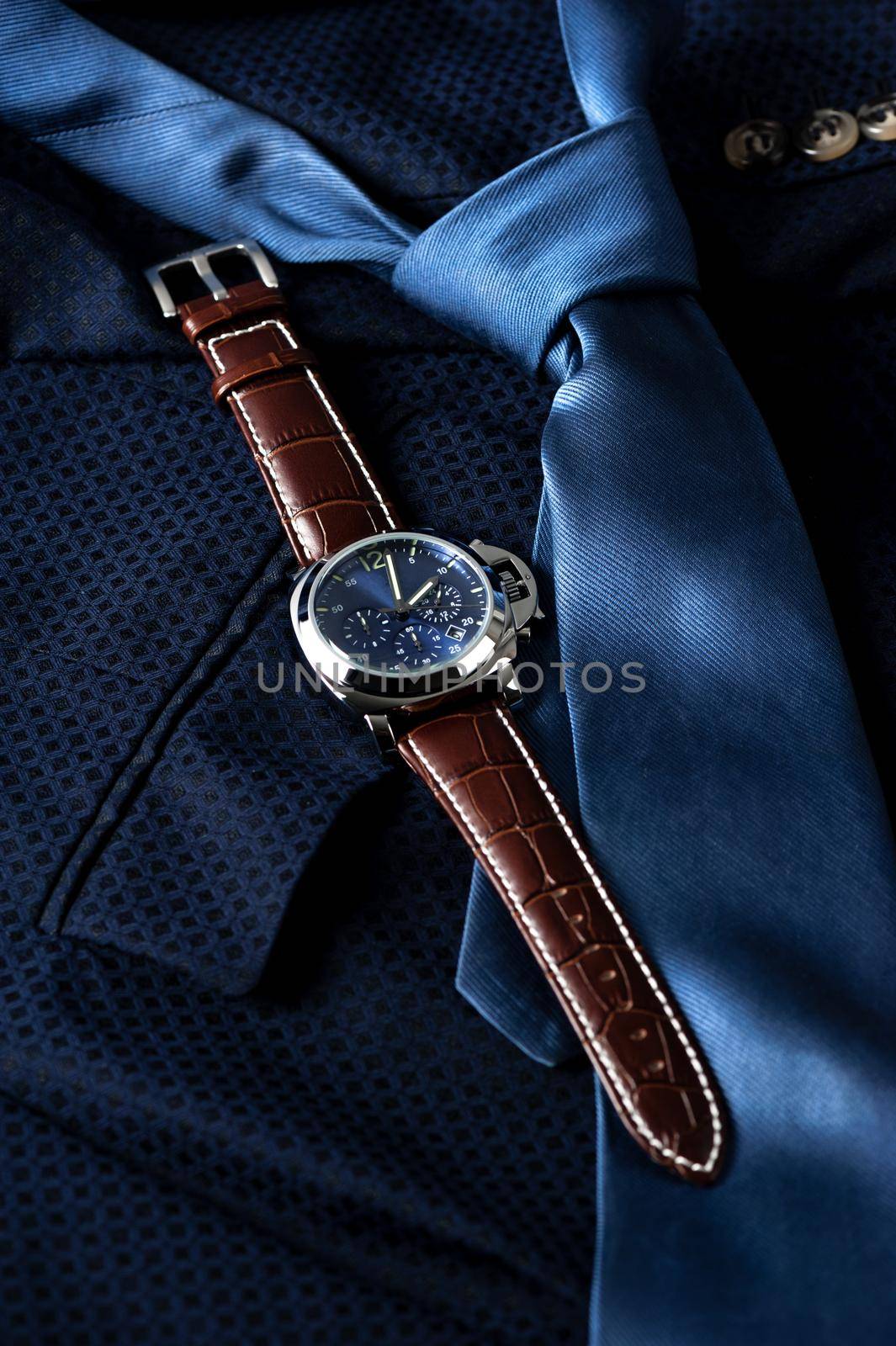 luxury fashion watch with blue dial and brown crocodile grain leather watch band