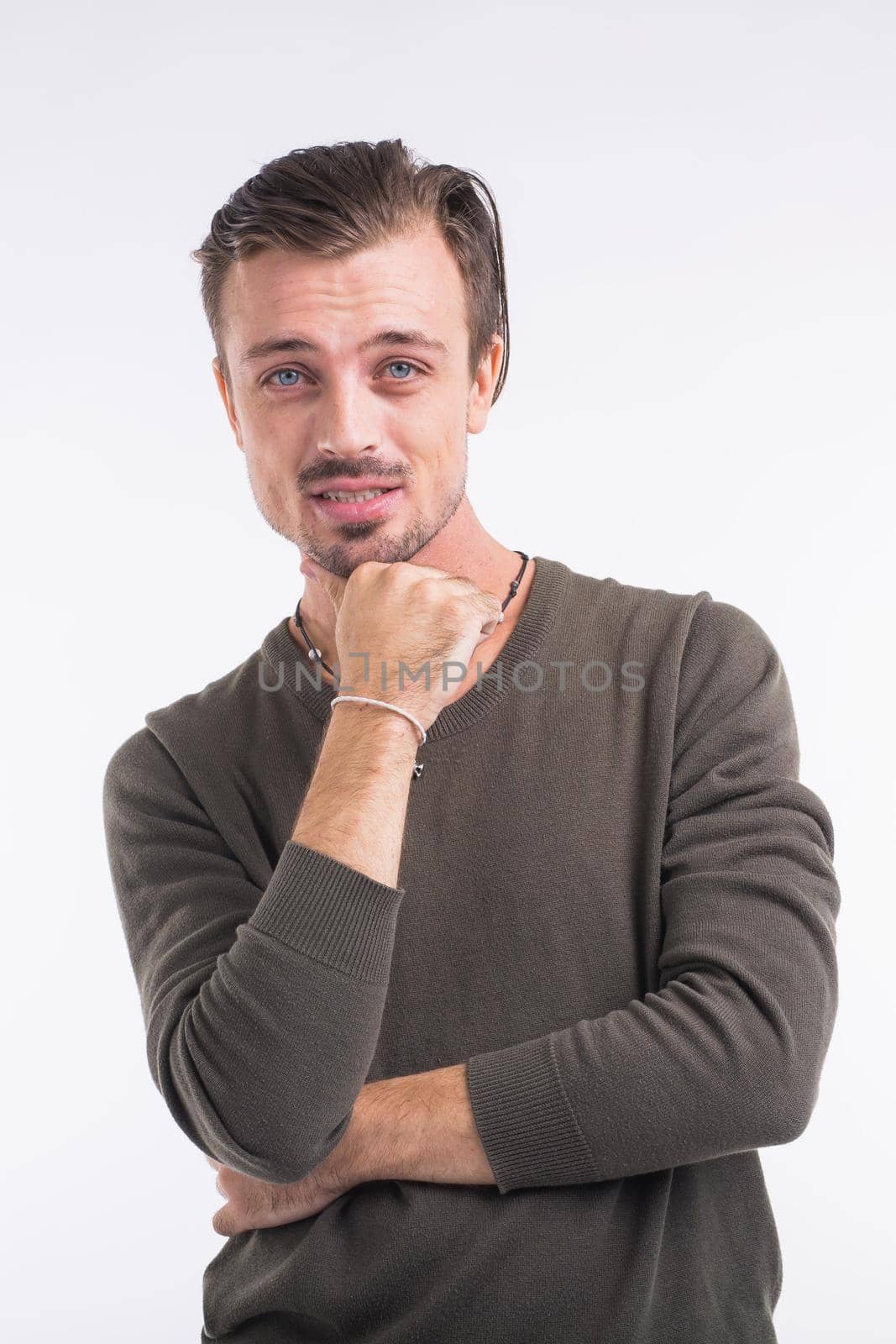 Thoughtful young man against white background.