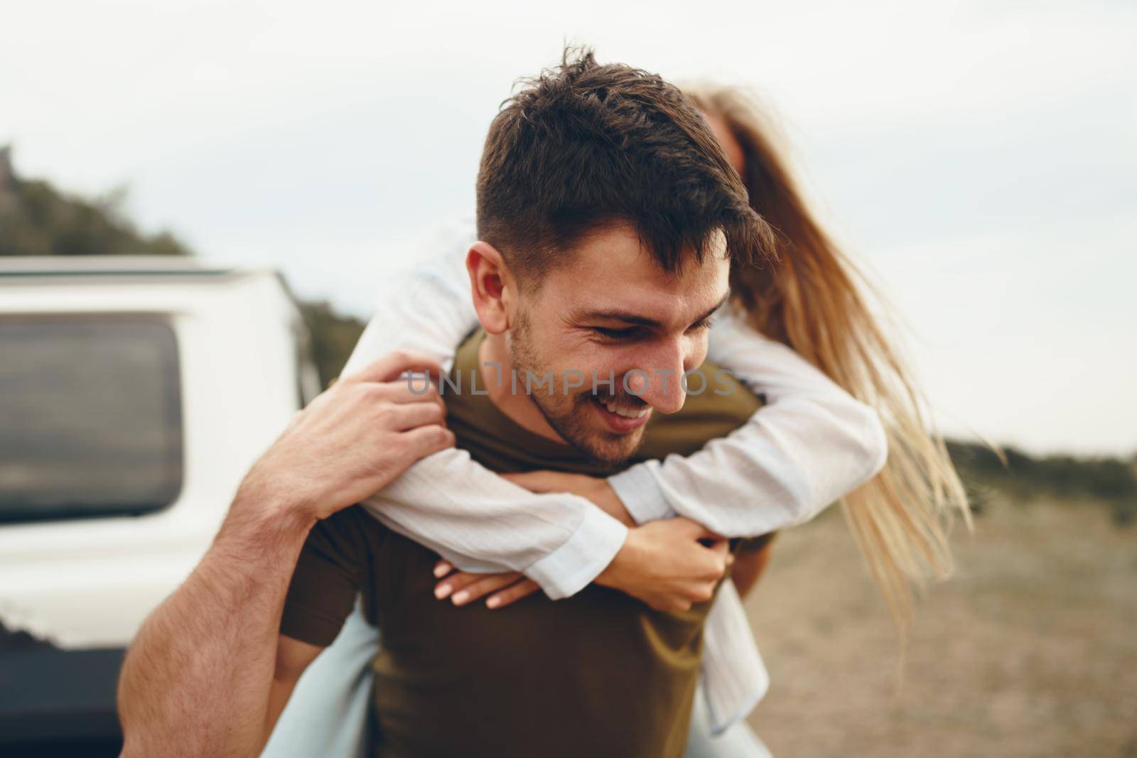 Young couple is on romantic trip to the mountains by car, close up