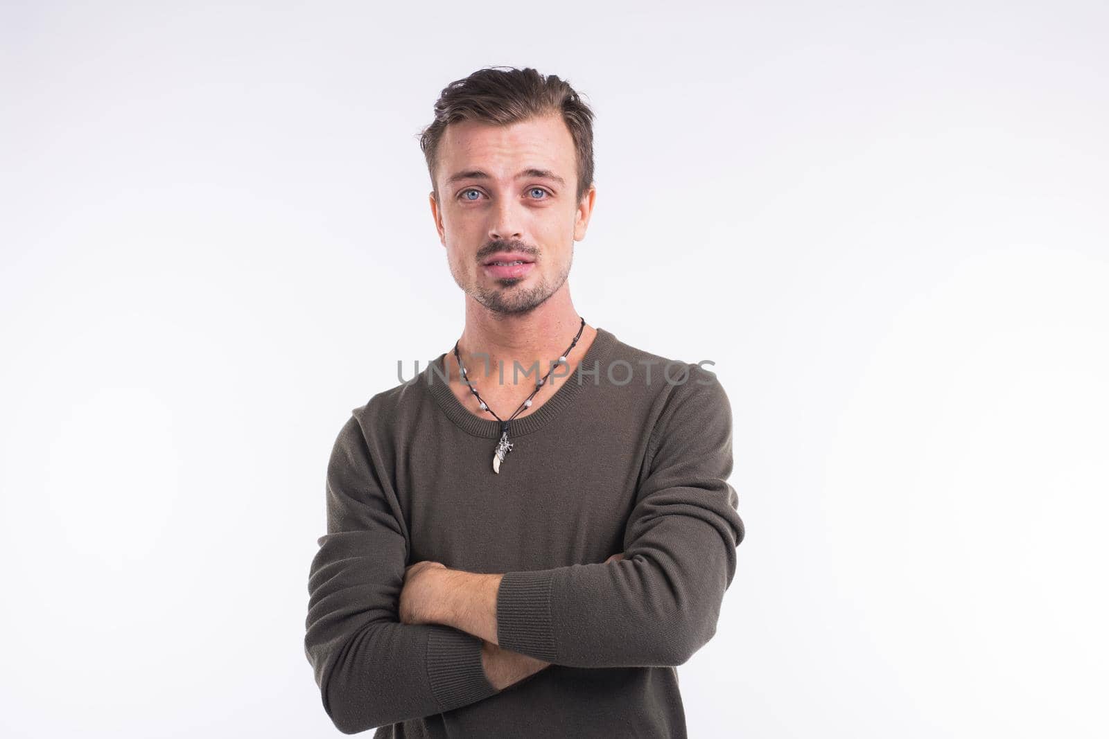 Thoughtful young man against white background.