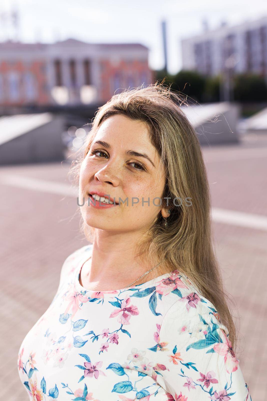 Pretty blonde woman smiling in the park. Summer, holidays and vacation concept
