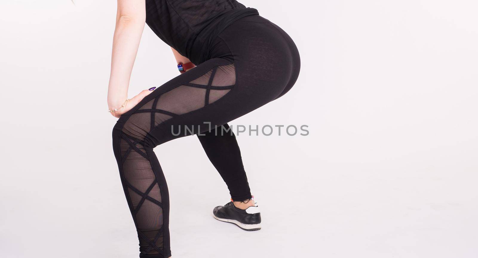 Close-up of girl dancing twerk in the dance class on white background by Satura86