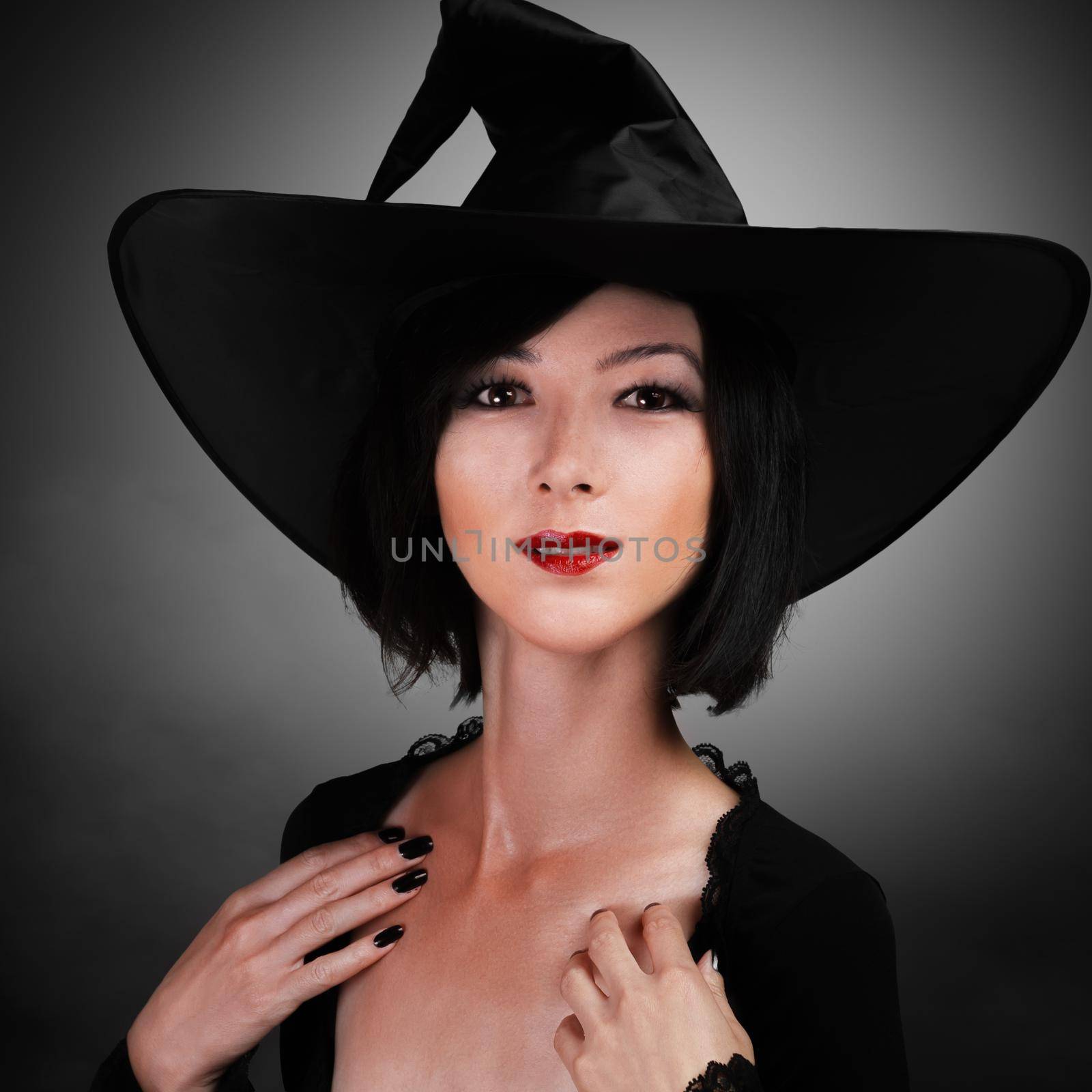 Beautiful young woman in a witch costume