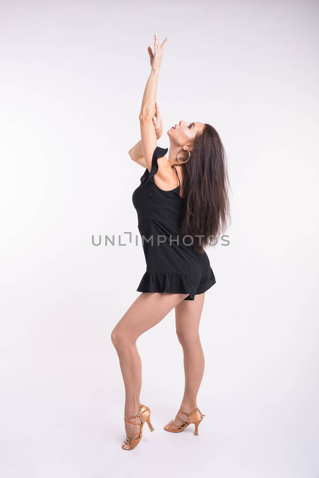 Latina dance, strip dance, contemporary and bachata lady concept - Woman dancing improvisation and moving her long hair on a white background. by Satura86