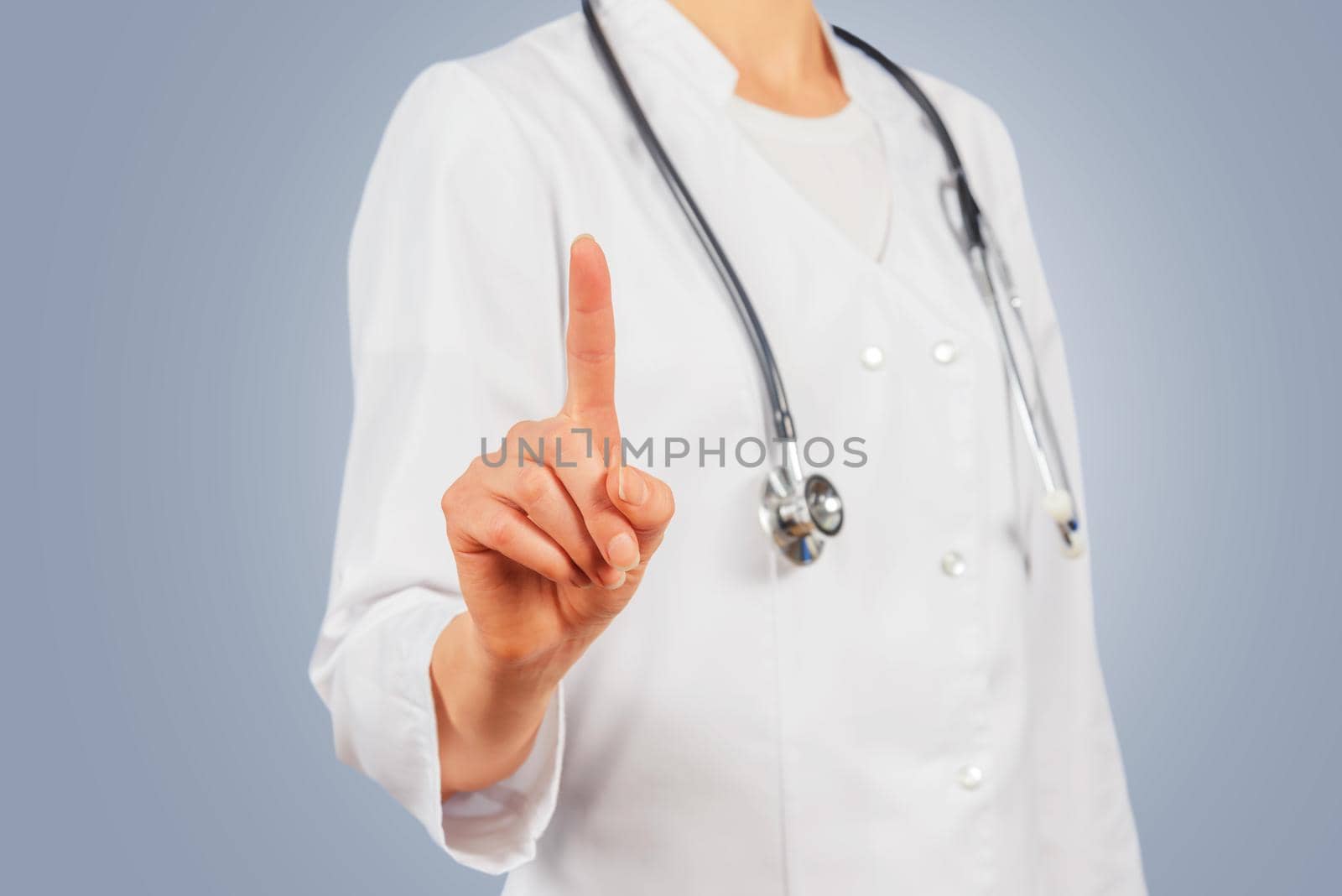 Unrecognizable female doctor is touching something in the air, copyspace