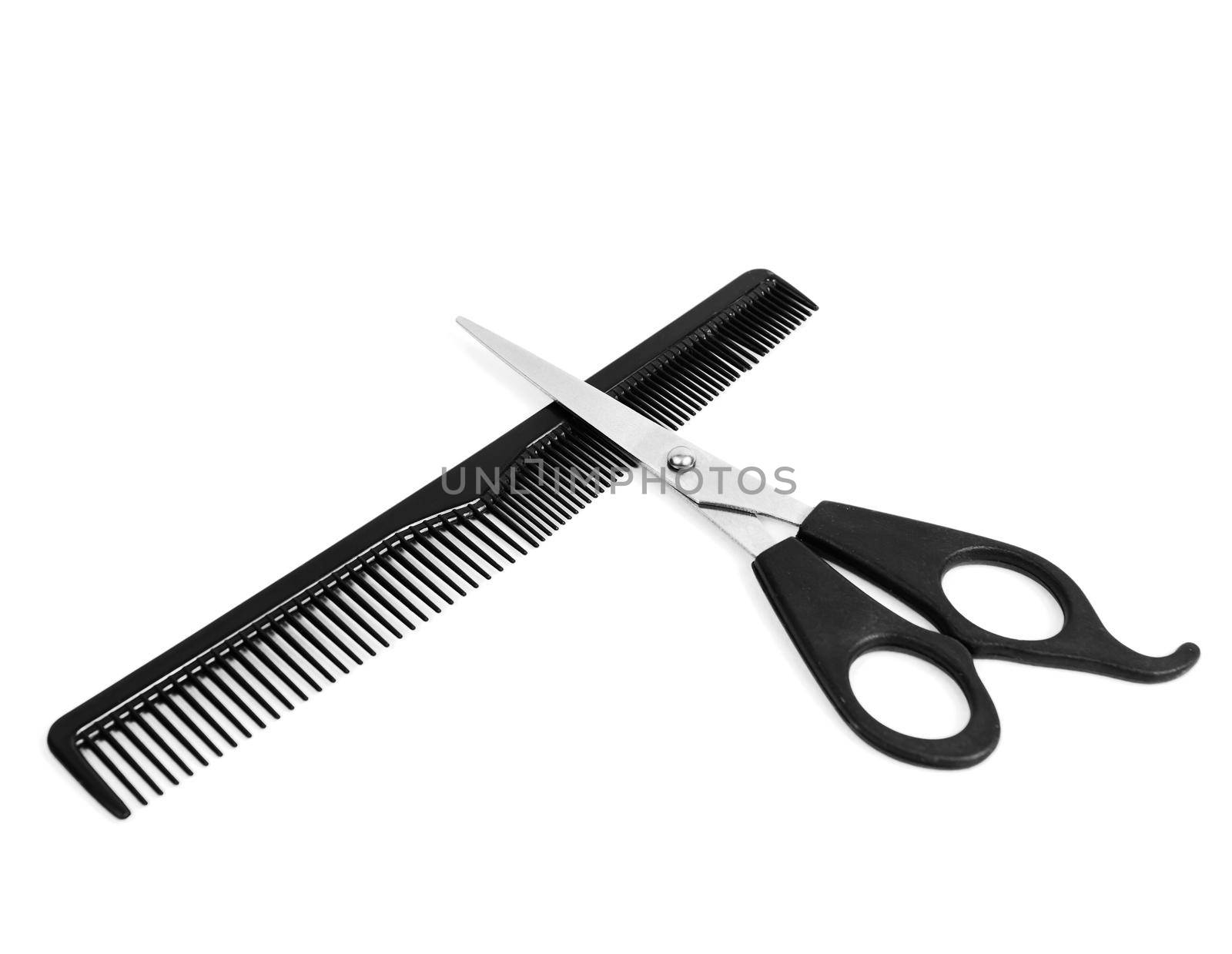 Comb and scissors on white background