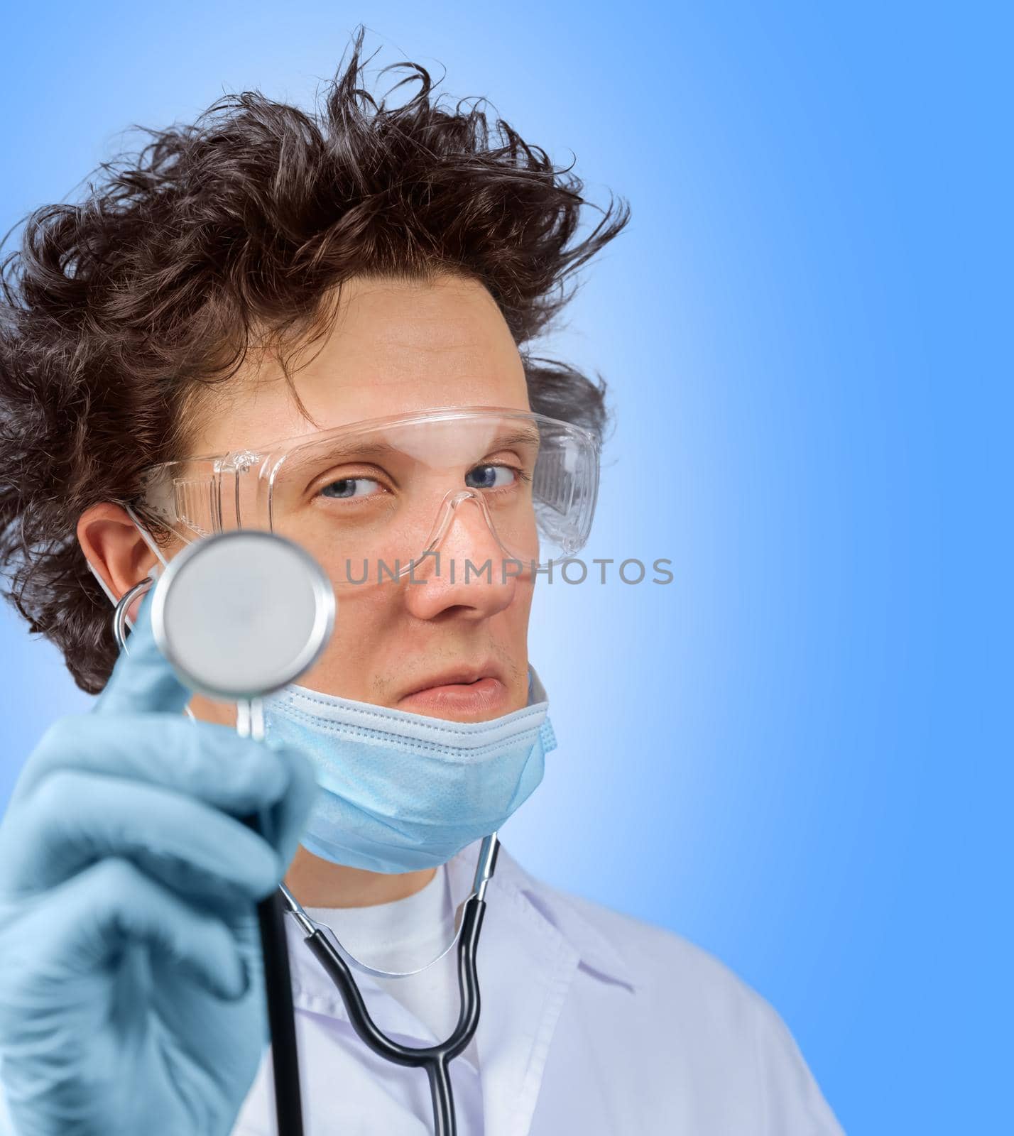 Funny doctor listens with stethoscope something in the air, space for text