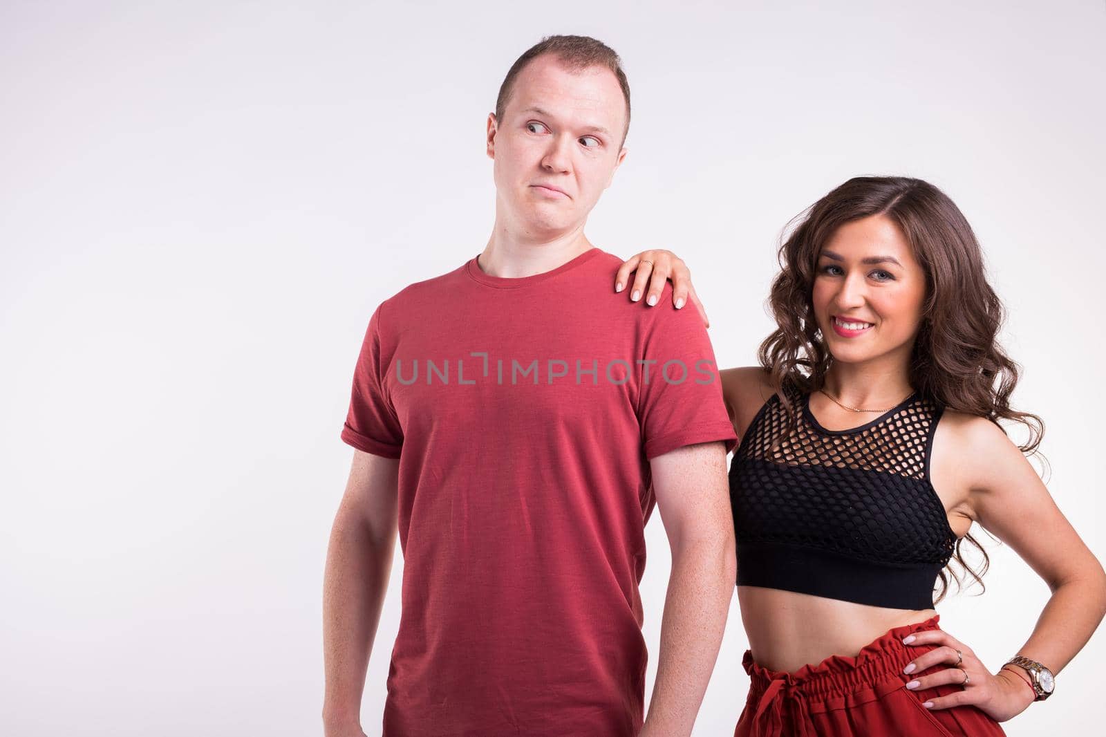 Portrait of young healthy sporty couple hugging on white background. by Satura86