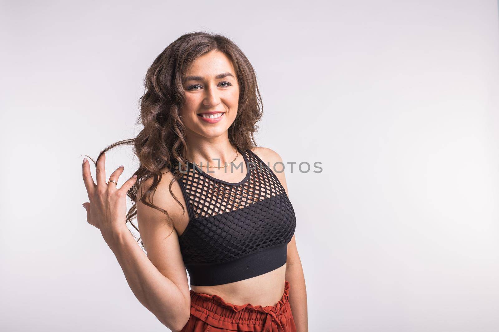 Latina dance, strip dance, contemporary and bachata lady concept - Woman dancing improvisation and moving her long hair on a white background with copy space by Satura86