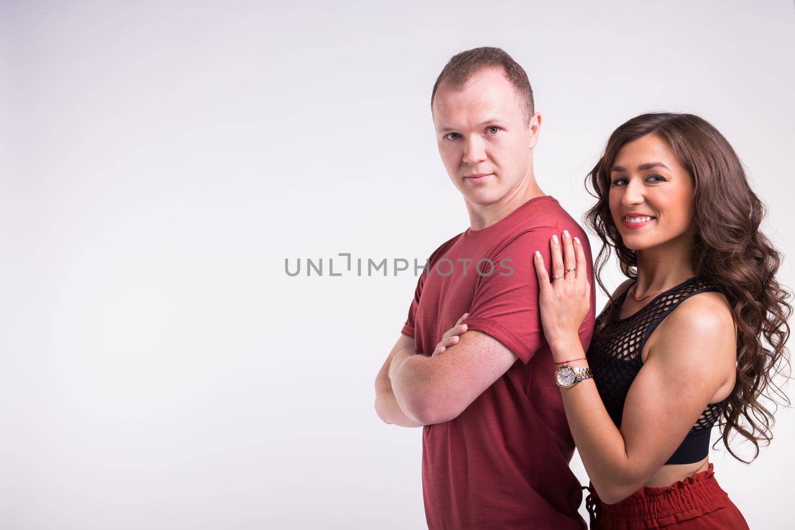 Portrait of young healthy sporty couple hugging on white background with copy space. by Satura86