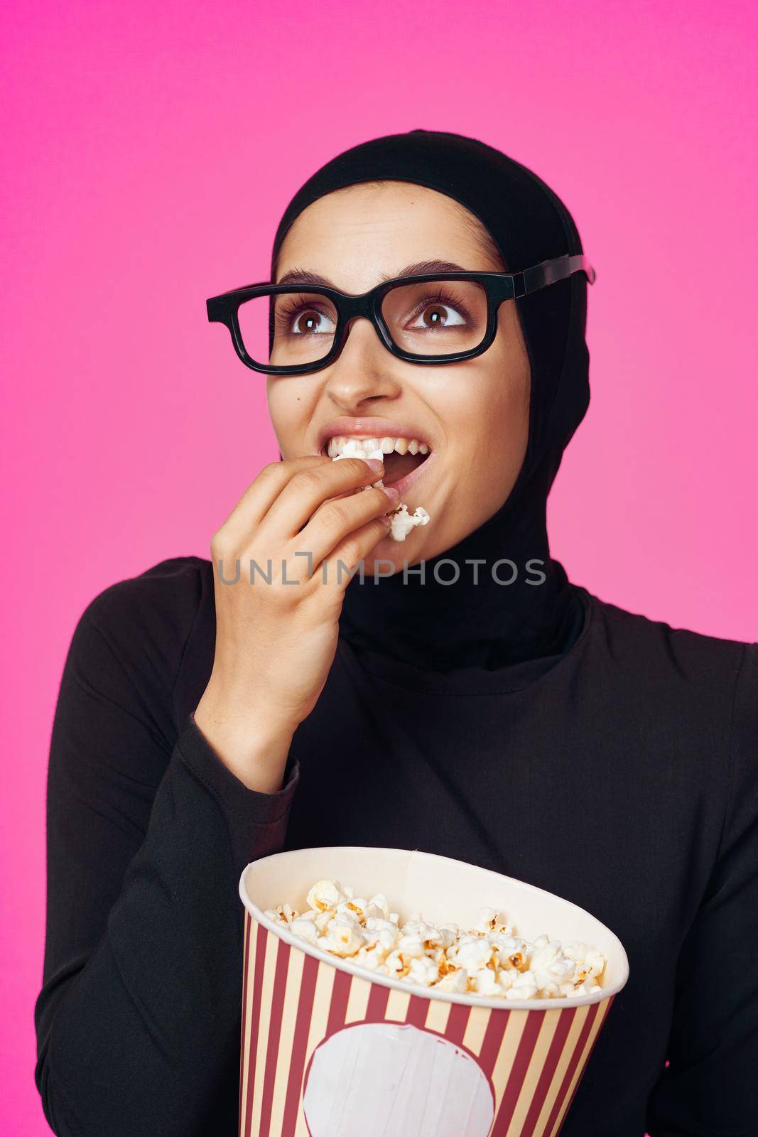 Muslim woman fun popcorn entertainment fashion isolated background. High quality photo