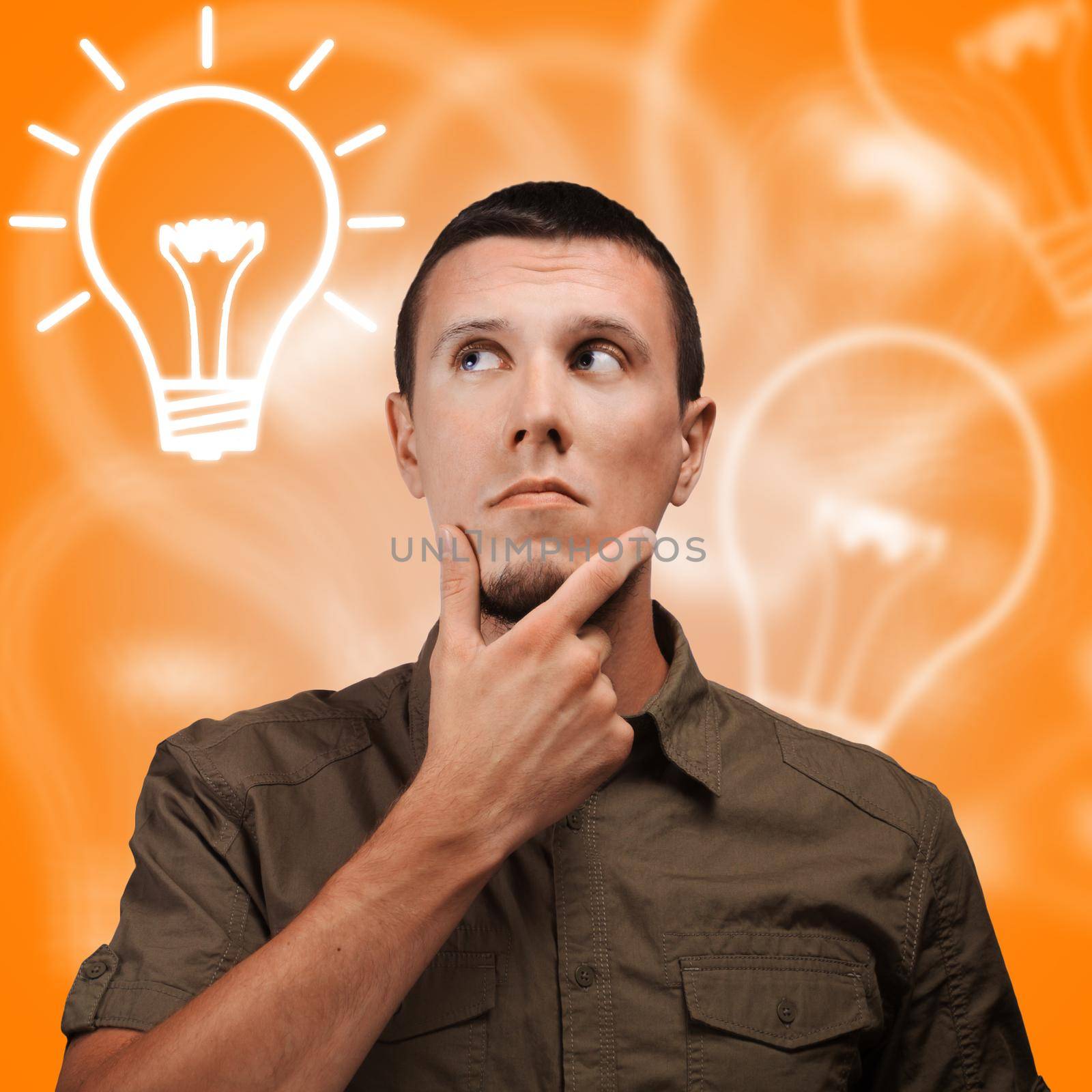 Young man thinking on an orange background with bulbs