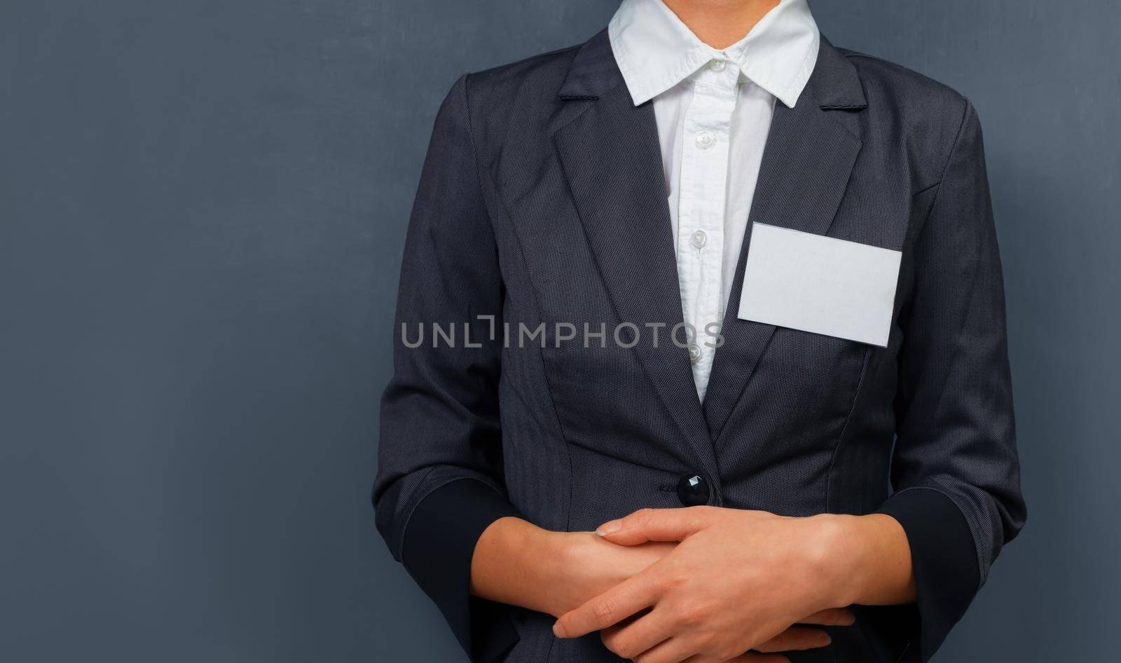 Businesswoman with a name tag on the chest, space for text
