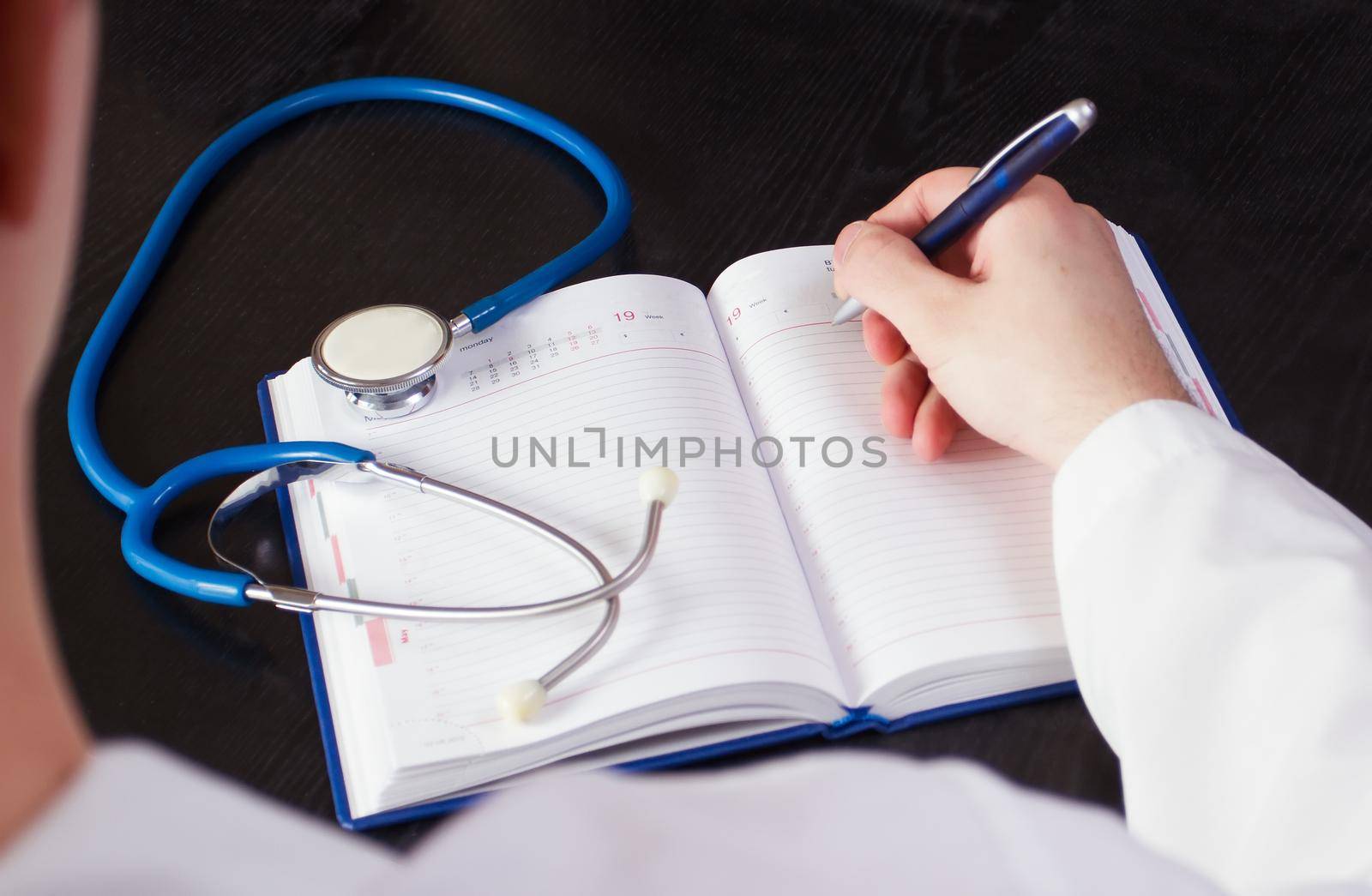 Doctor writing medical records