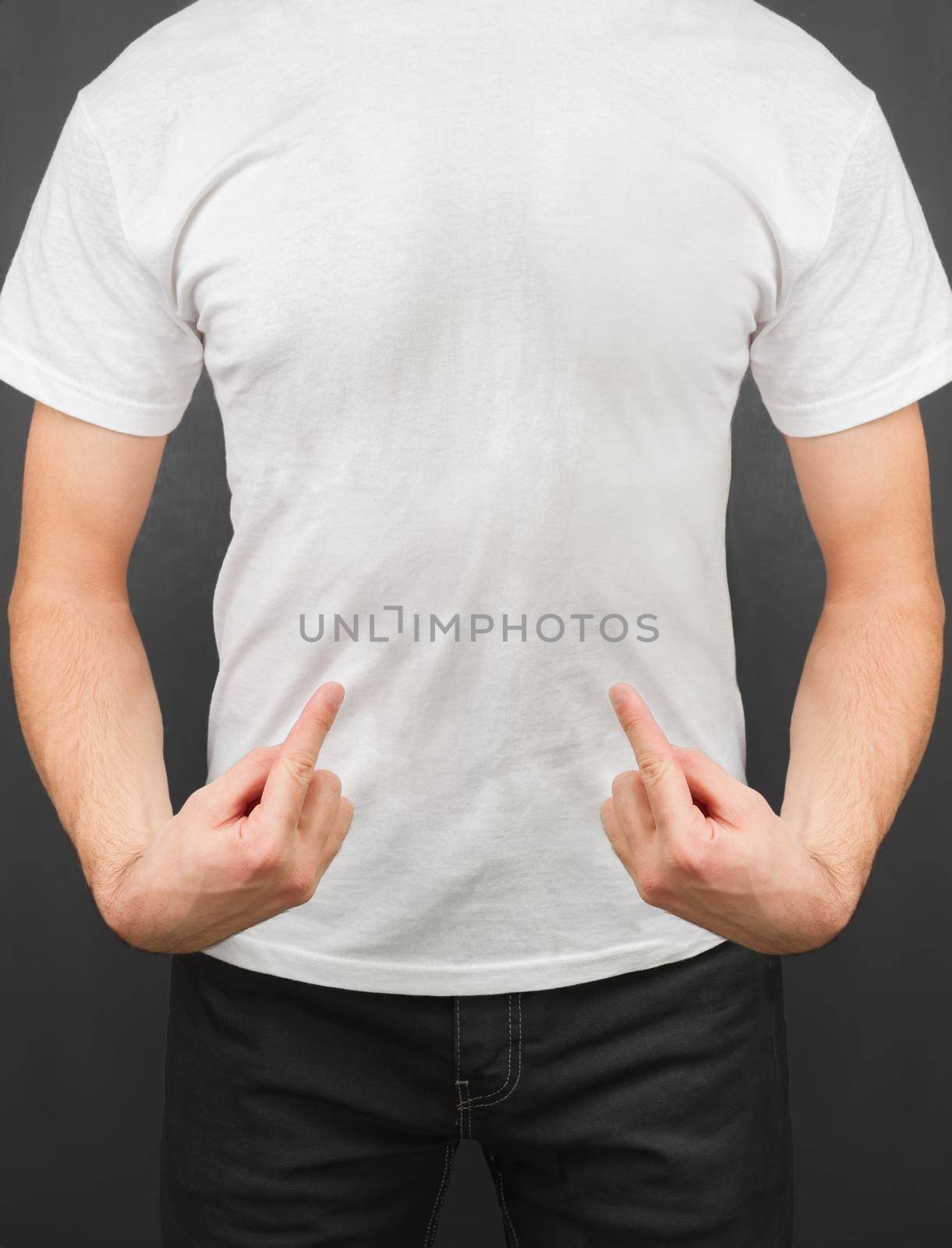 Unrecognizable man points to the white t-shirt, space for text