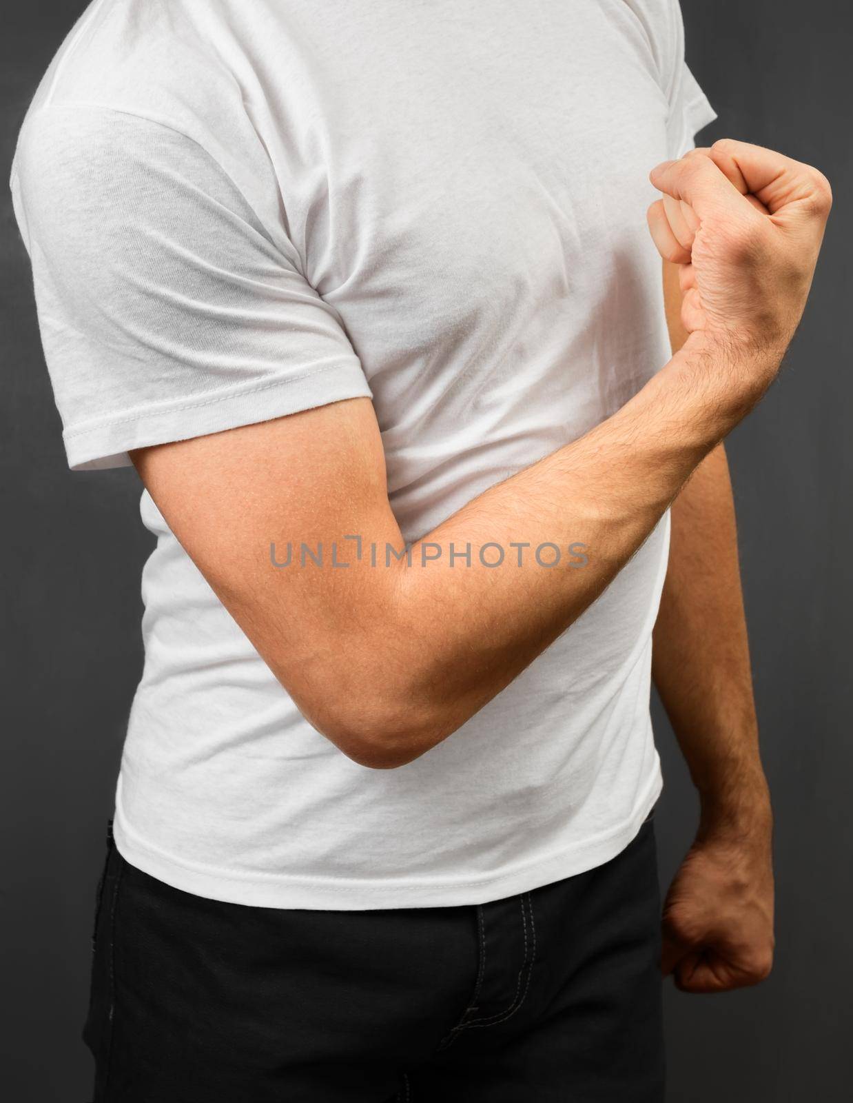 Unrecognizable man showing his strong biceps