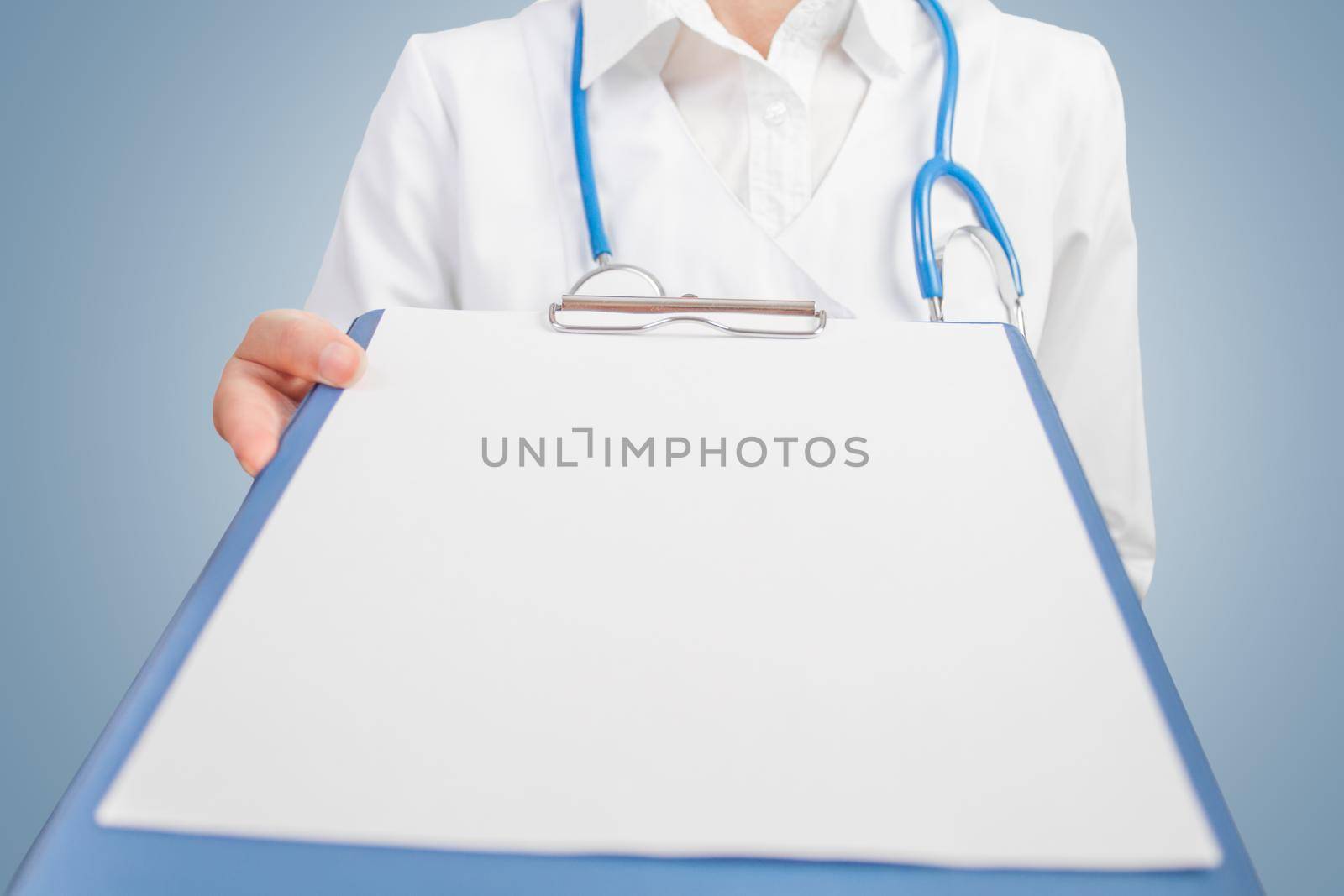 Doctor showing Clipboard with blank sheet. Space for text