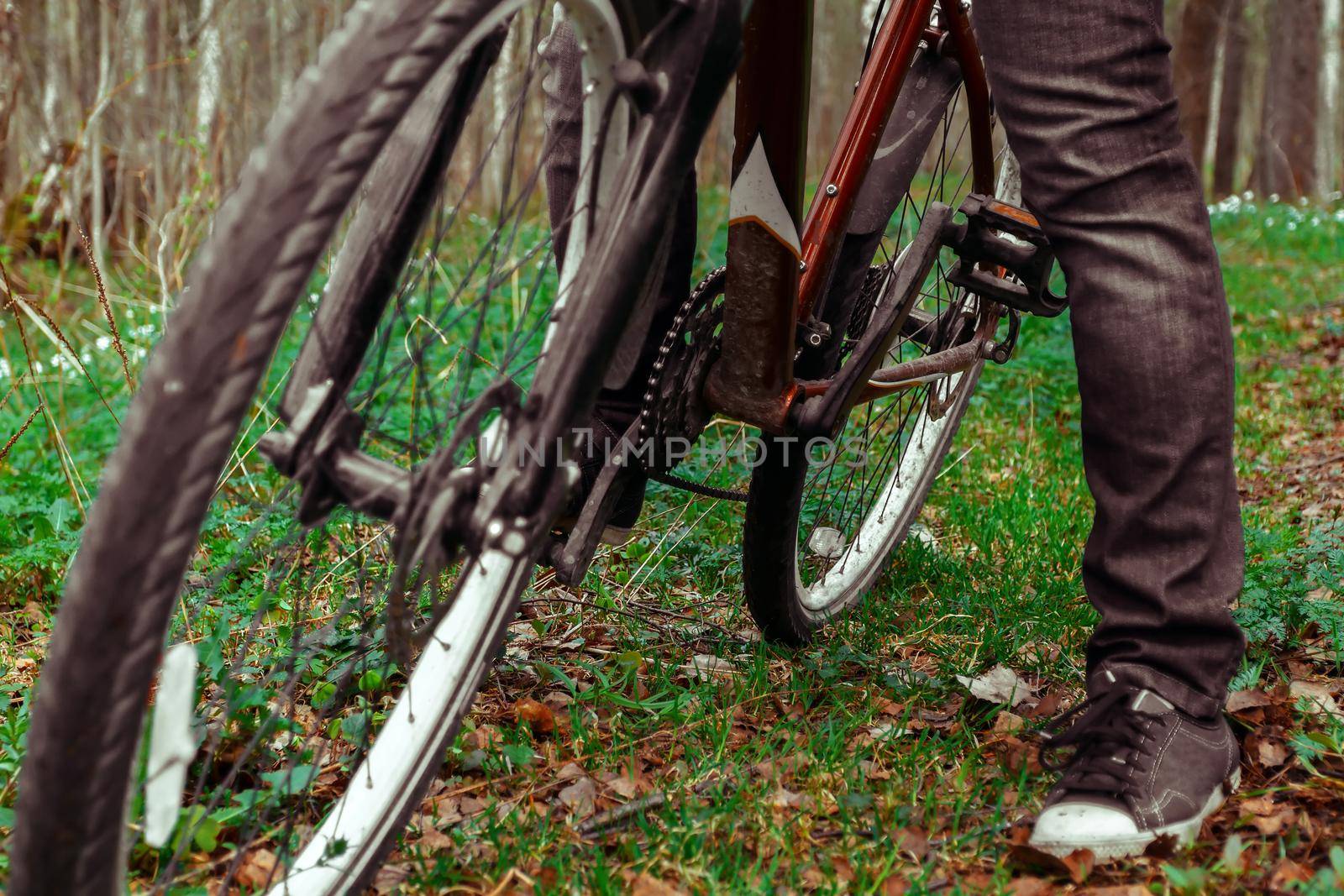 Woman on bicycle stopped, leaning on one leg