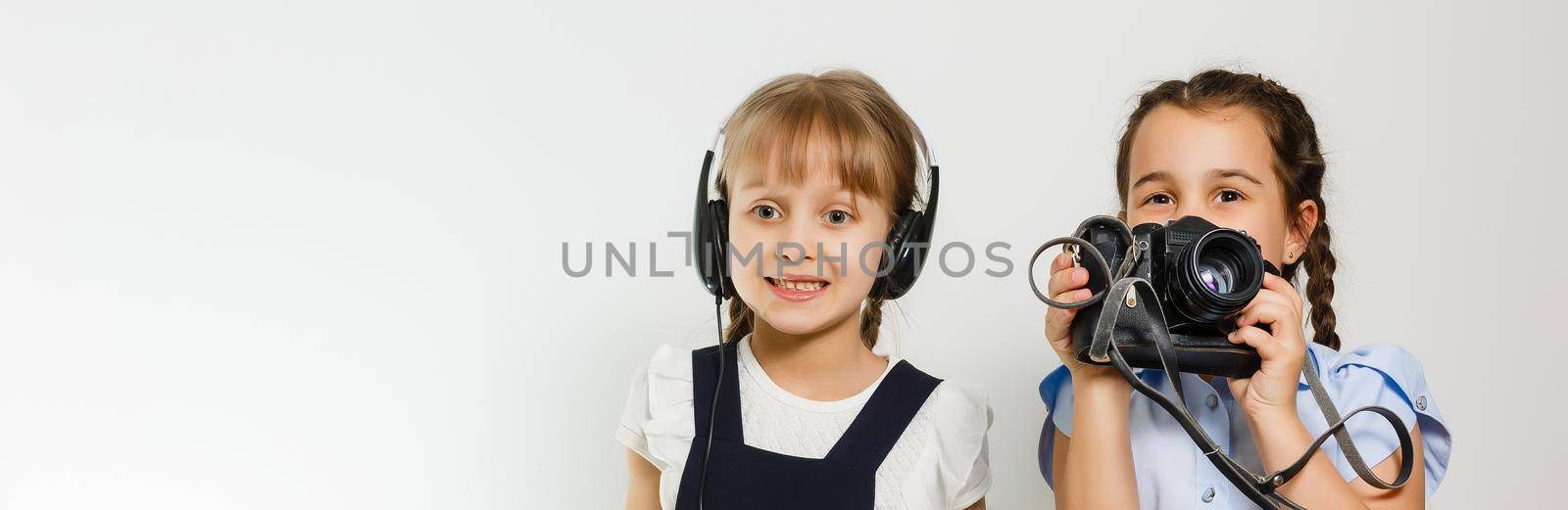 two little schoolgirls at recess. Children enjoy this recess. They smile fun. by Andelov13