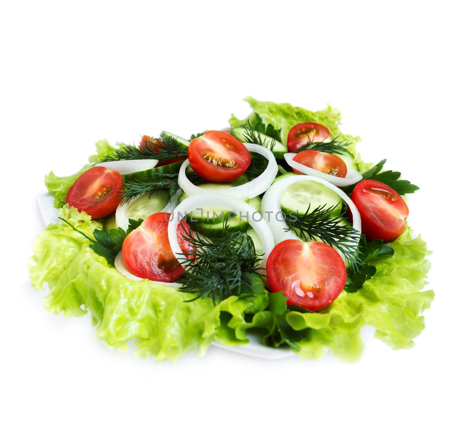 Fresh salad of cucumber, cherry tomatoes, onion rings and dill, side view